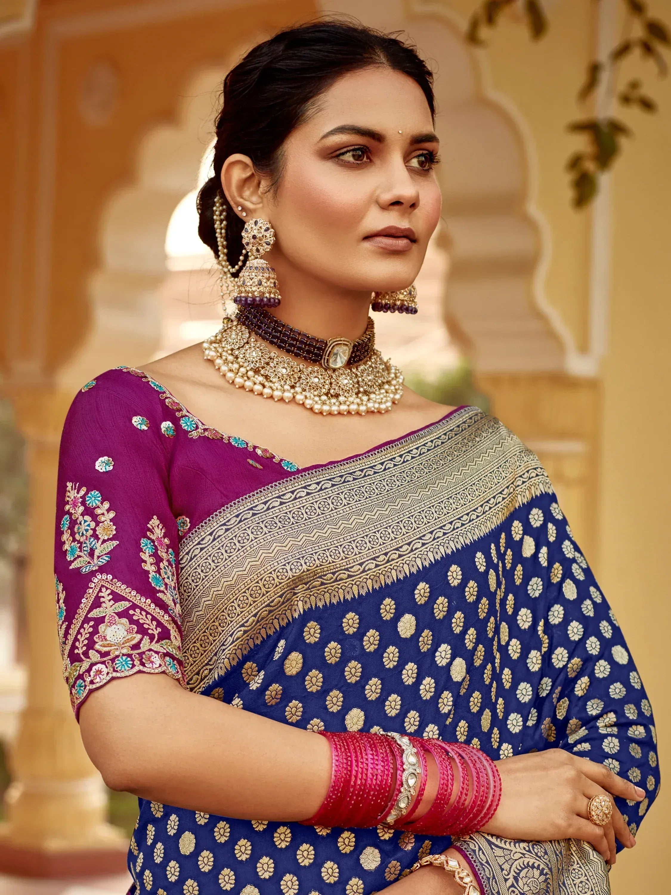 Elegant woman in blue and purple embroidered saree with gold jewelry, perfect for Indian ethnic wear.