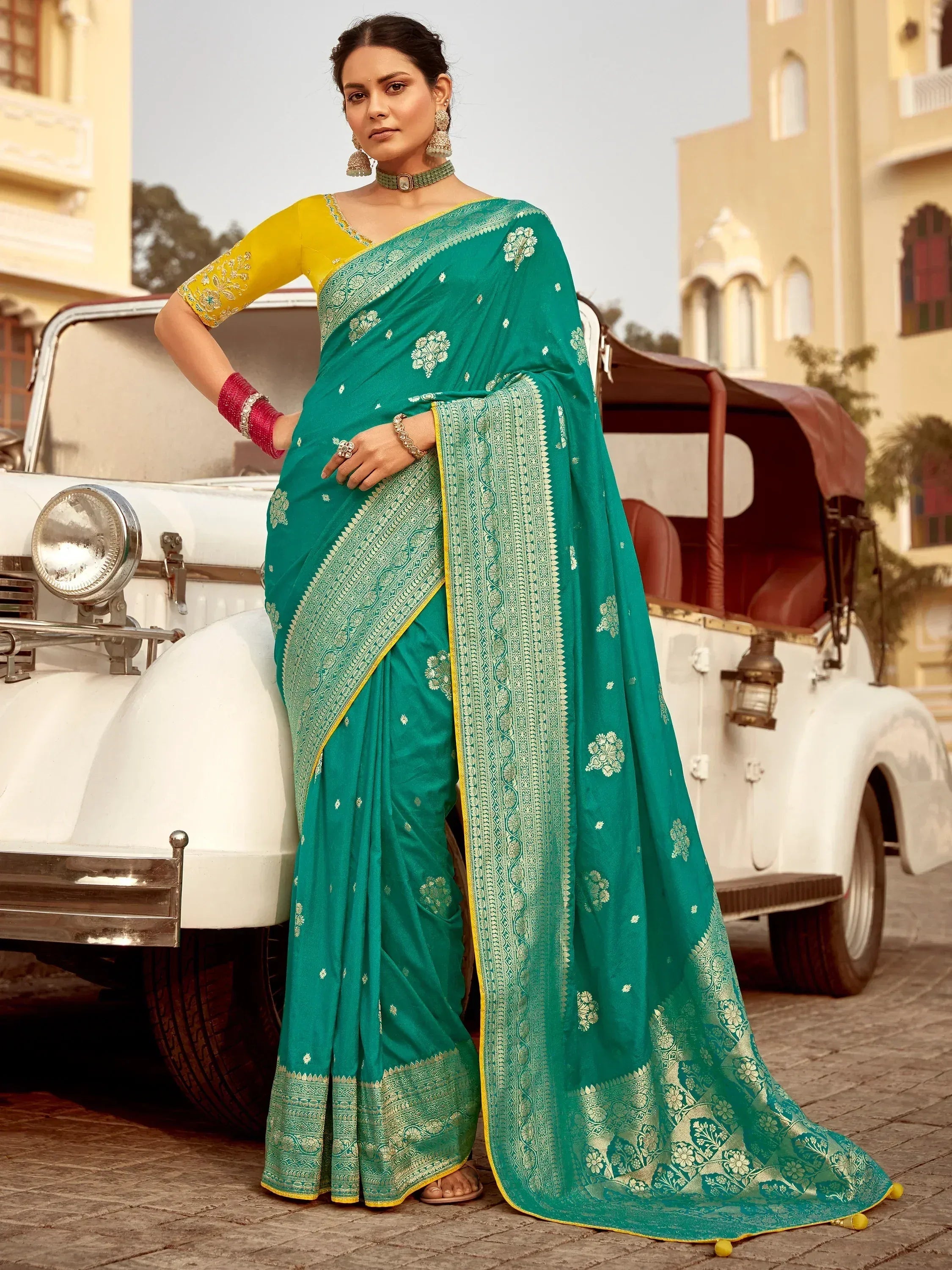 Emerald green designer saree with gold embroidery, paired with yellow blouse, perfect for Indian ethnic occasions.