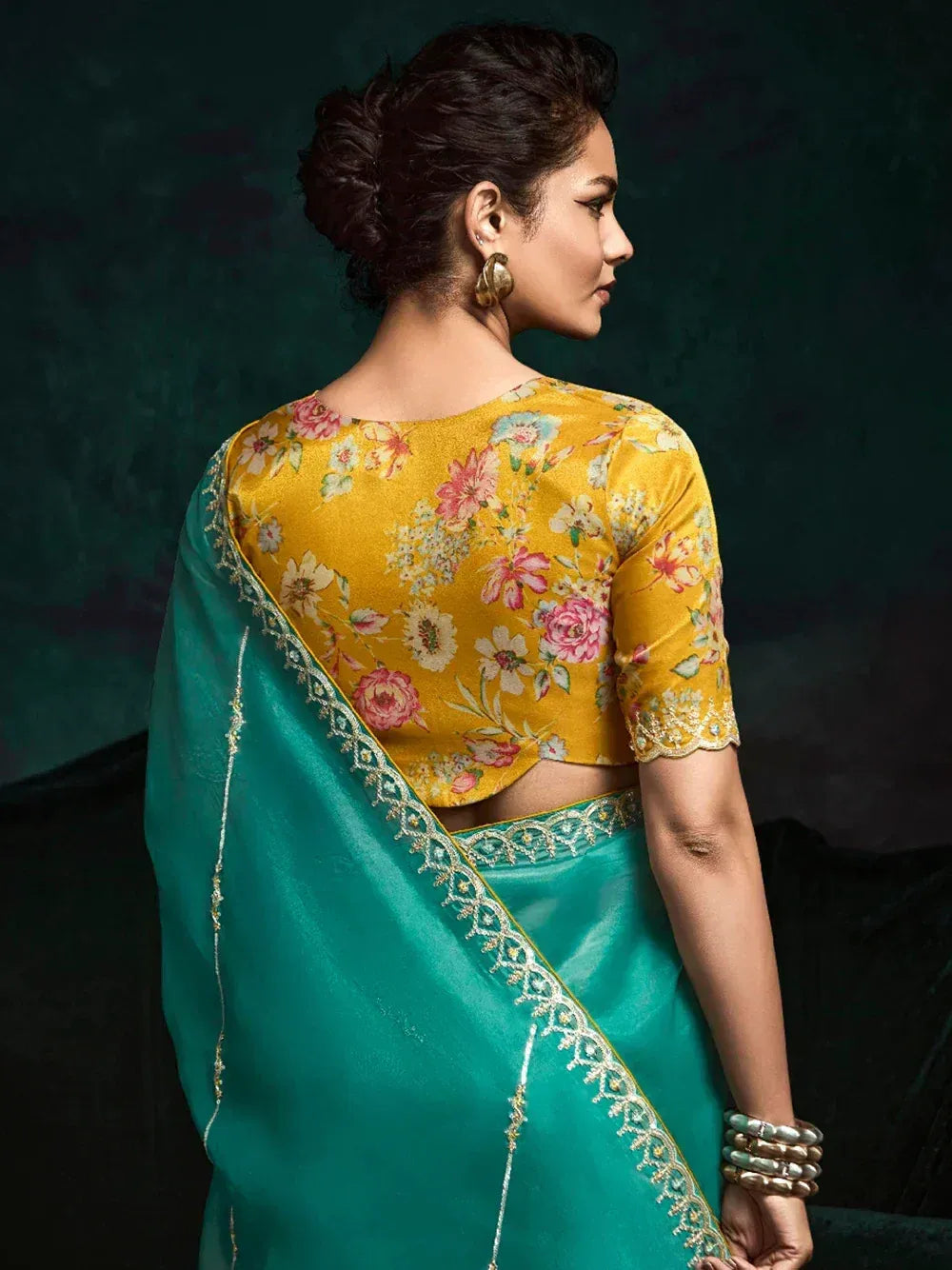 Woman in teal saree with floral yellow blouse, ethnic Indian wear