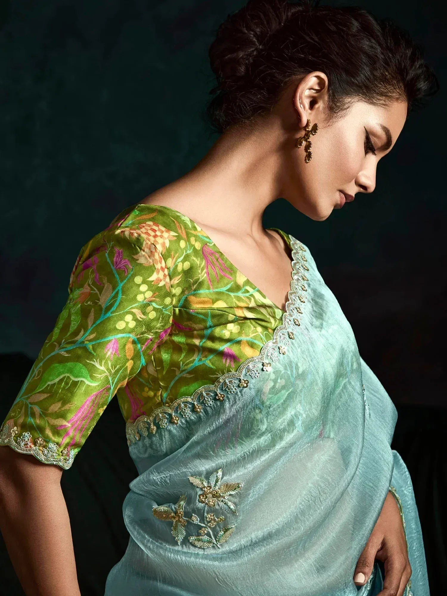 Woman in elegant mint green saree with floral embroidered green blouse, perfect for Indian ethnic occasions.