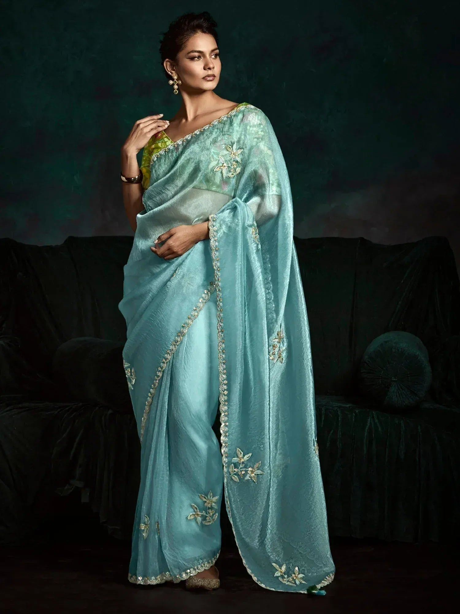 Elegant turquoise saree with gold floral embroidery, perfect for Indian ethnic wear occasions.