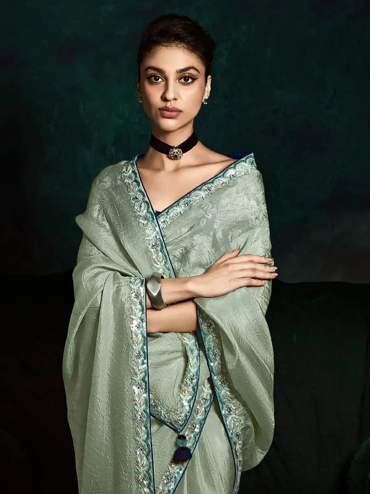 Elegant mint green designer saree with intricate embroidery and blue border, perfect for Indian ethnic occasions.