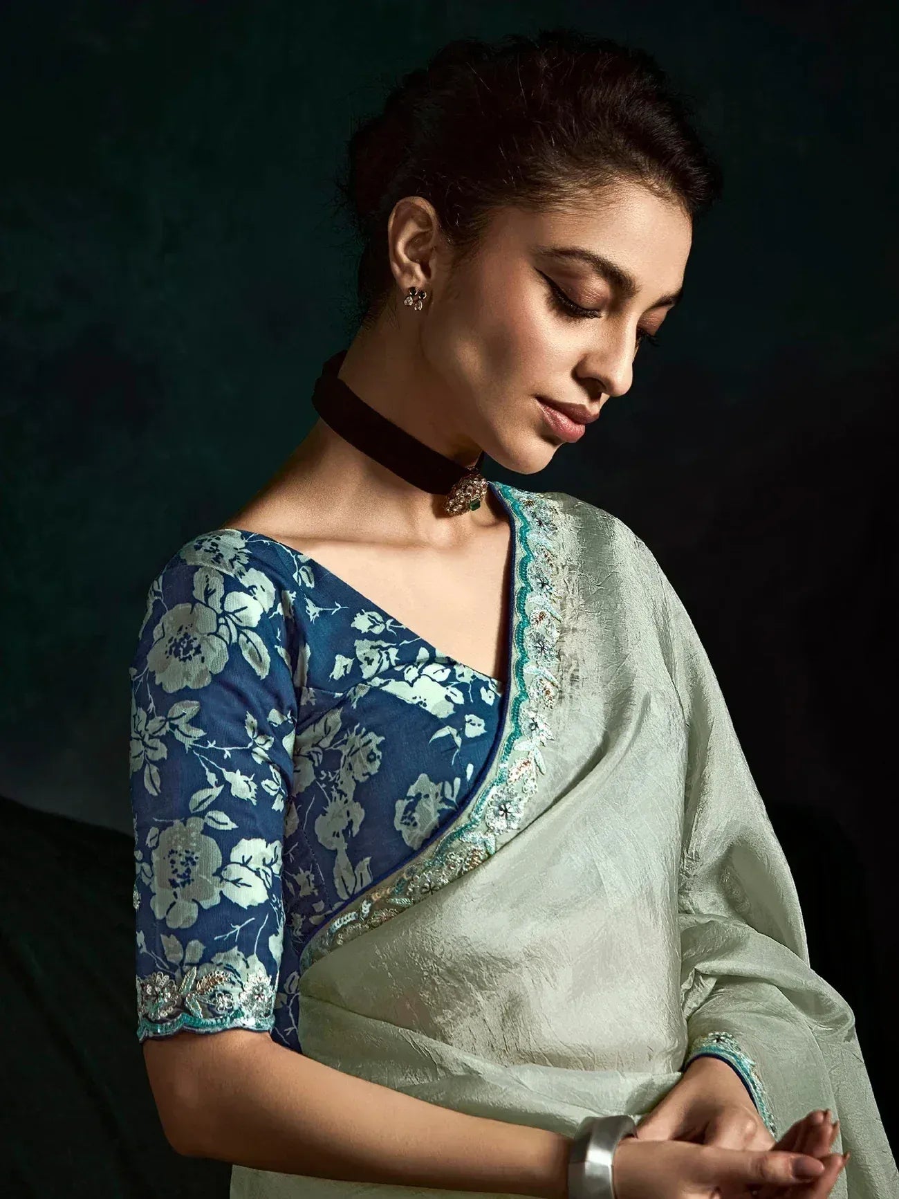 Elegant light green saree with blue floral blouse, perfect for Indian ethnic wear occasions.