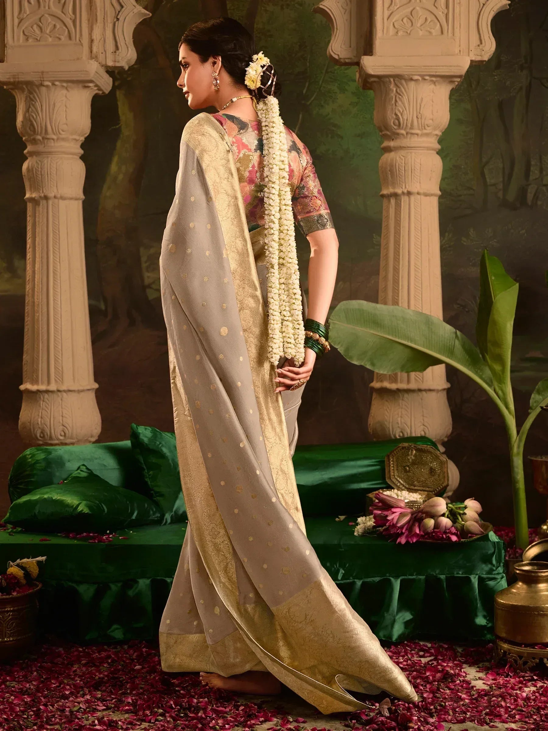 Elegant Indian saree with gold border and floral blouse, styled with jasmine garland for traditional occasions