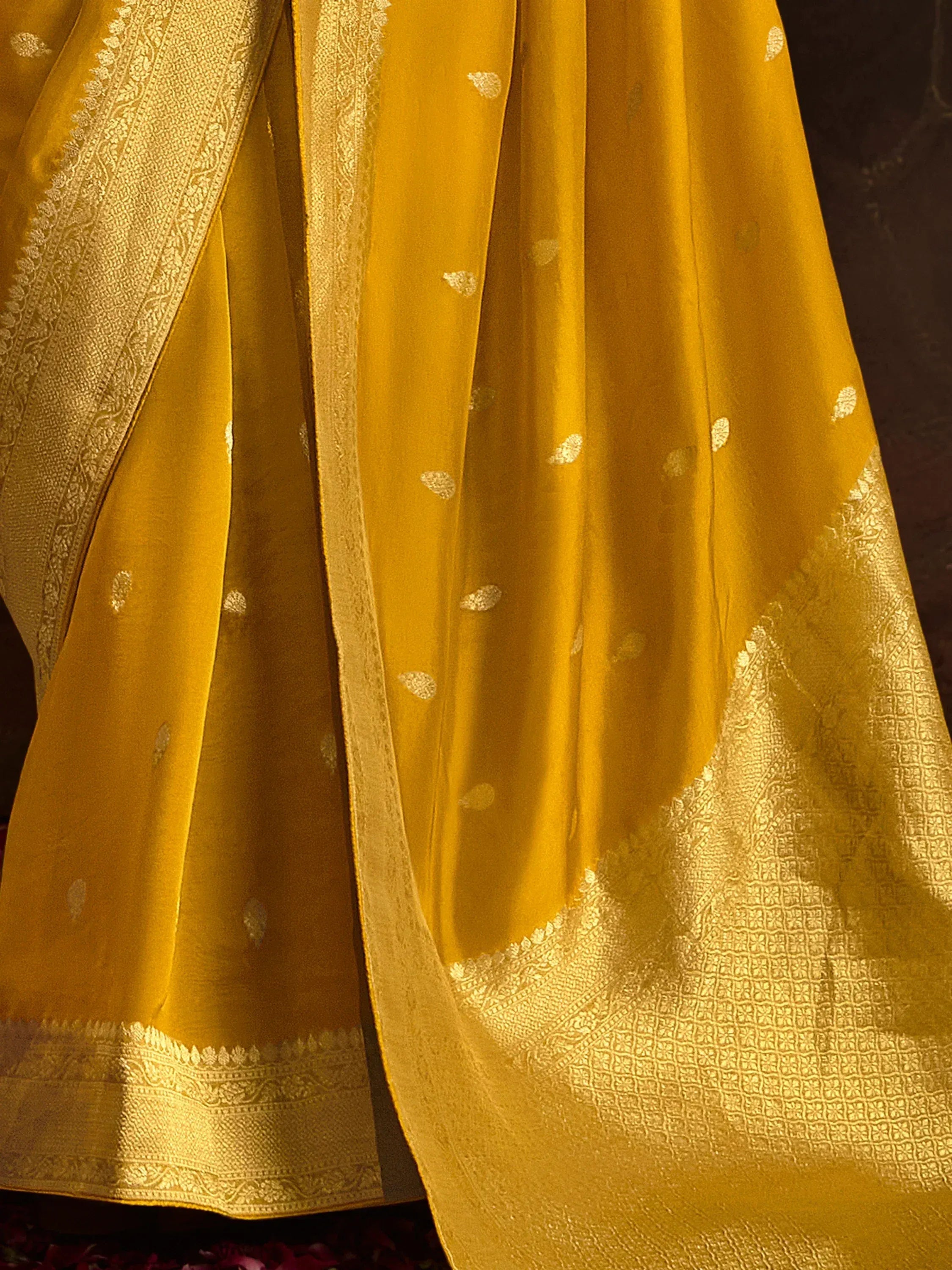 Golden yellow ethnic saree with intricate gold zari border and buta motifs, perfect for Indian occasions