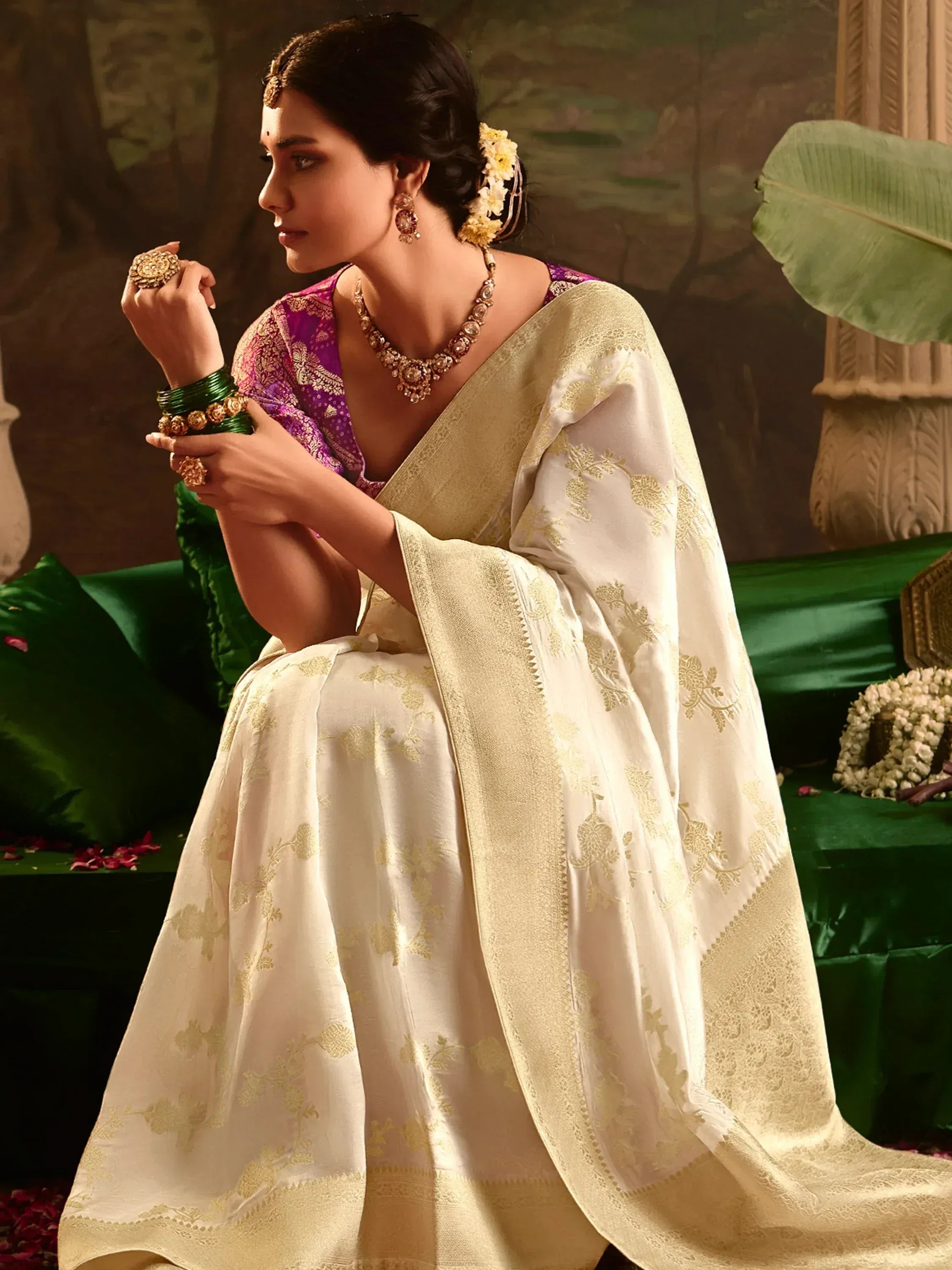 Elegant woman in cream and gold embroidered saree with purple blouse, traditional Indian ethnic wear