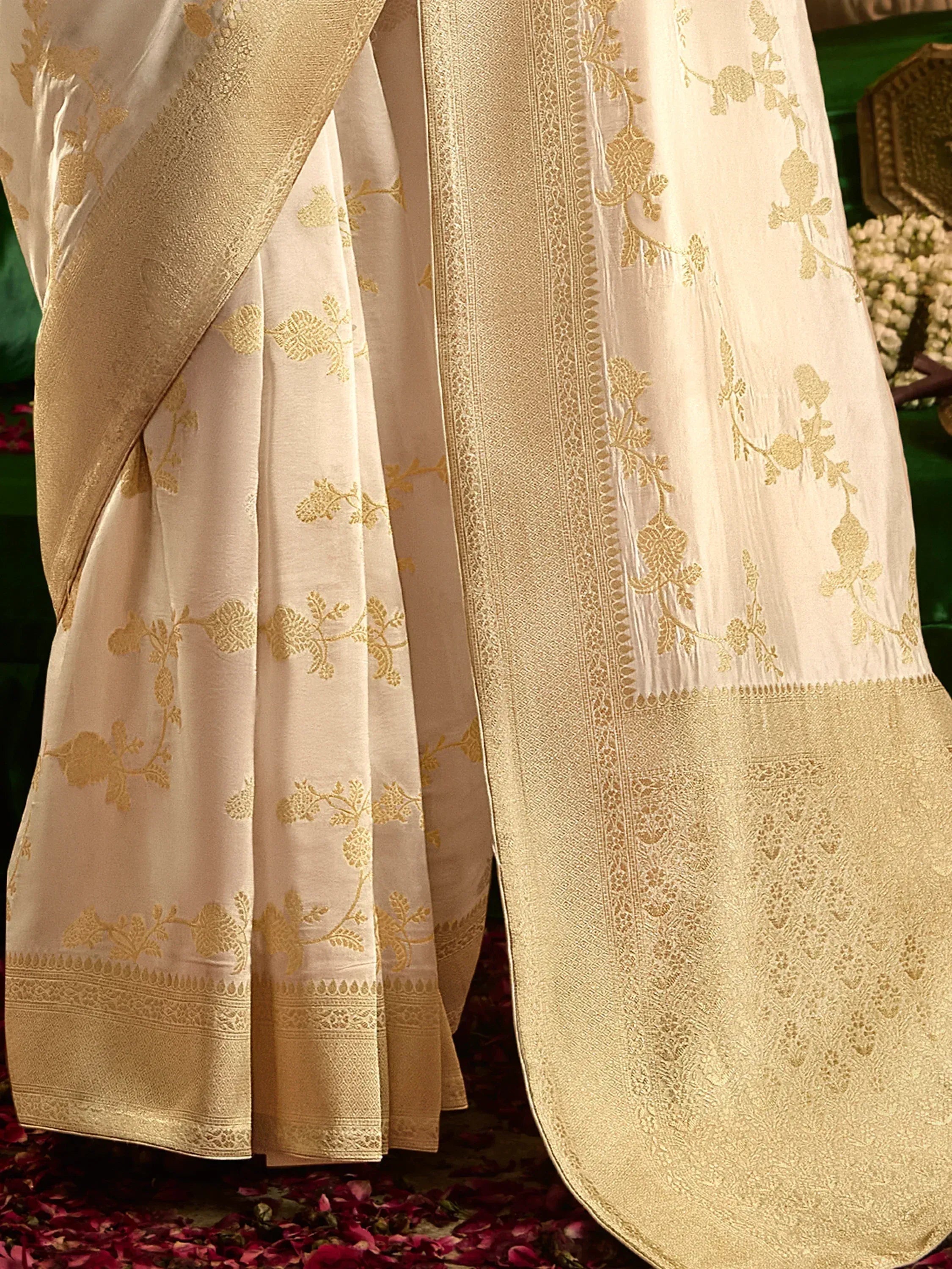 Cream and gold embroidered saree with floral motifs and heavy border, ideal for ethnic occasions