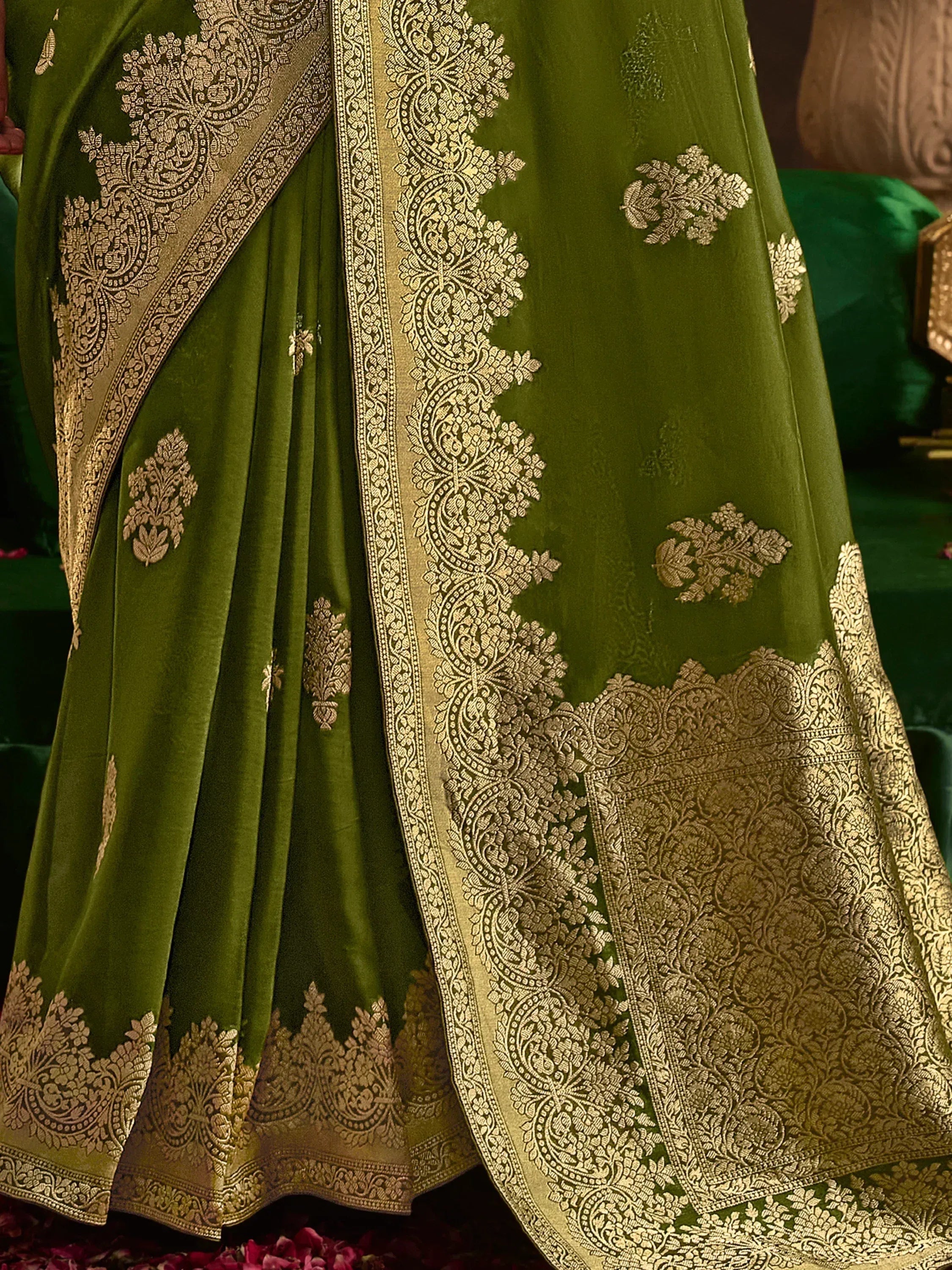 Emerald green ethnic lehenga with intricate gold embroidery and detailed border work for festive occasions