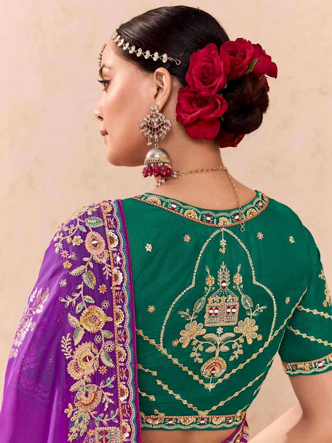 Green embroidered blouse with purple dupatta, red rose hair accessory, and traditional Indian jewelry