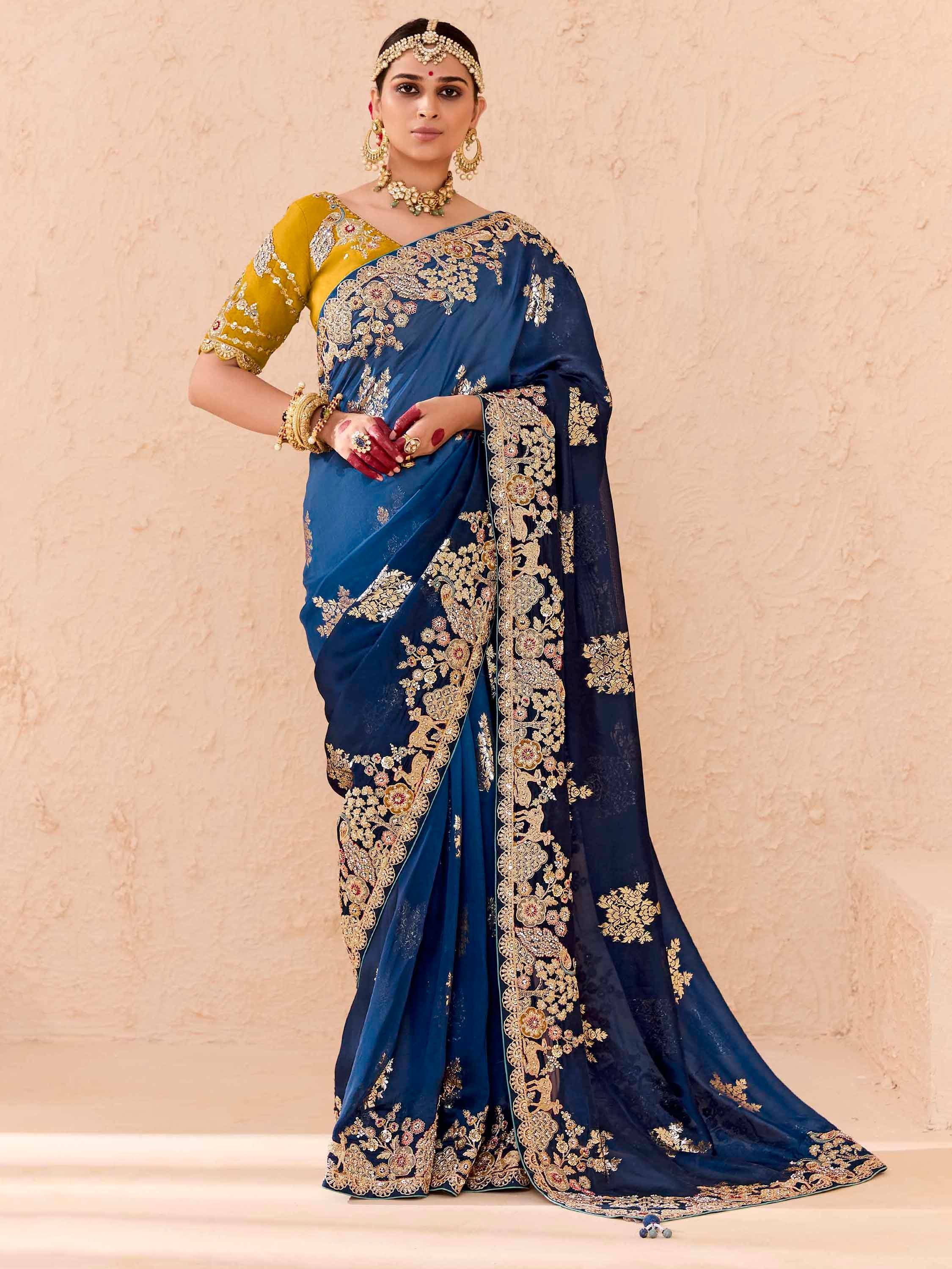 Elegant navy blue saree with gold embroidery and yellow blouse, perfect for Indian ethnic occasions.