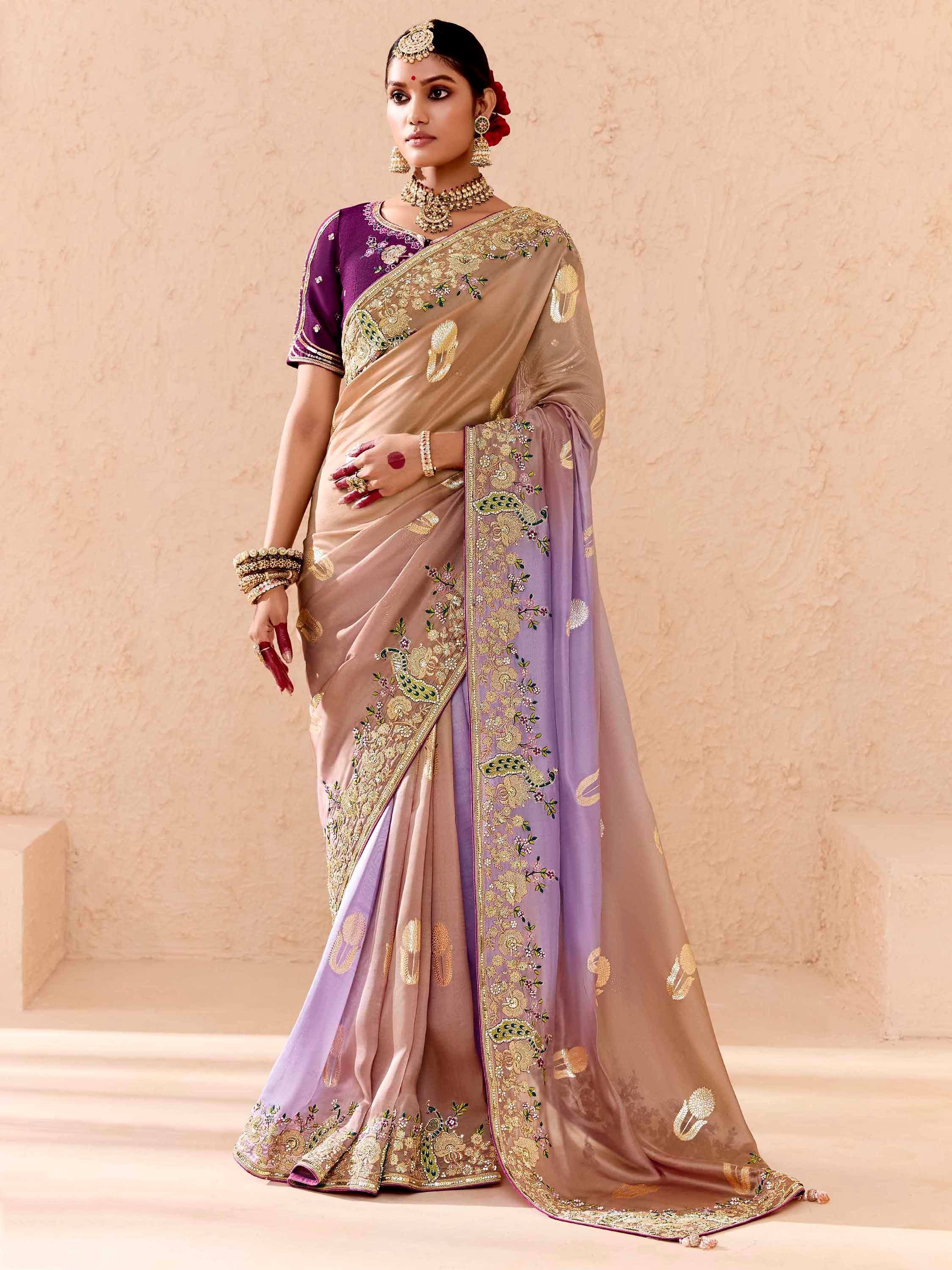 Elegant beige and purple saree with gold floral embroidery and peacock motifs, perfect for Indian ethnic wear occasions.
