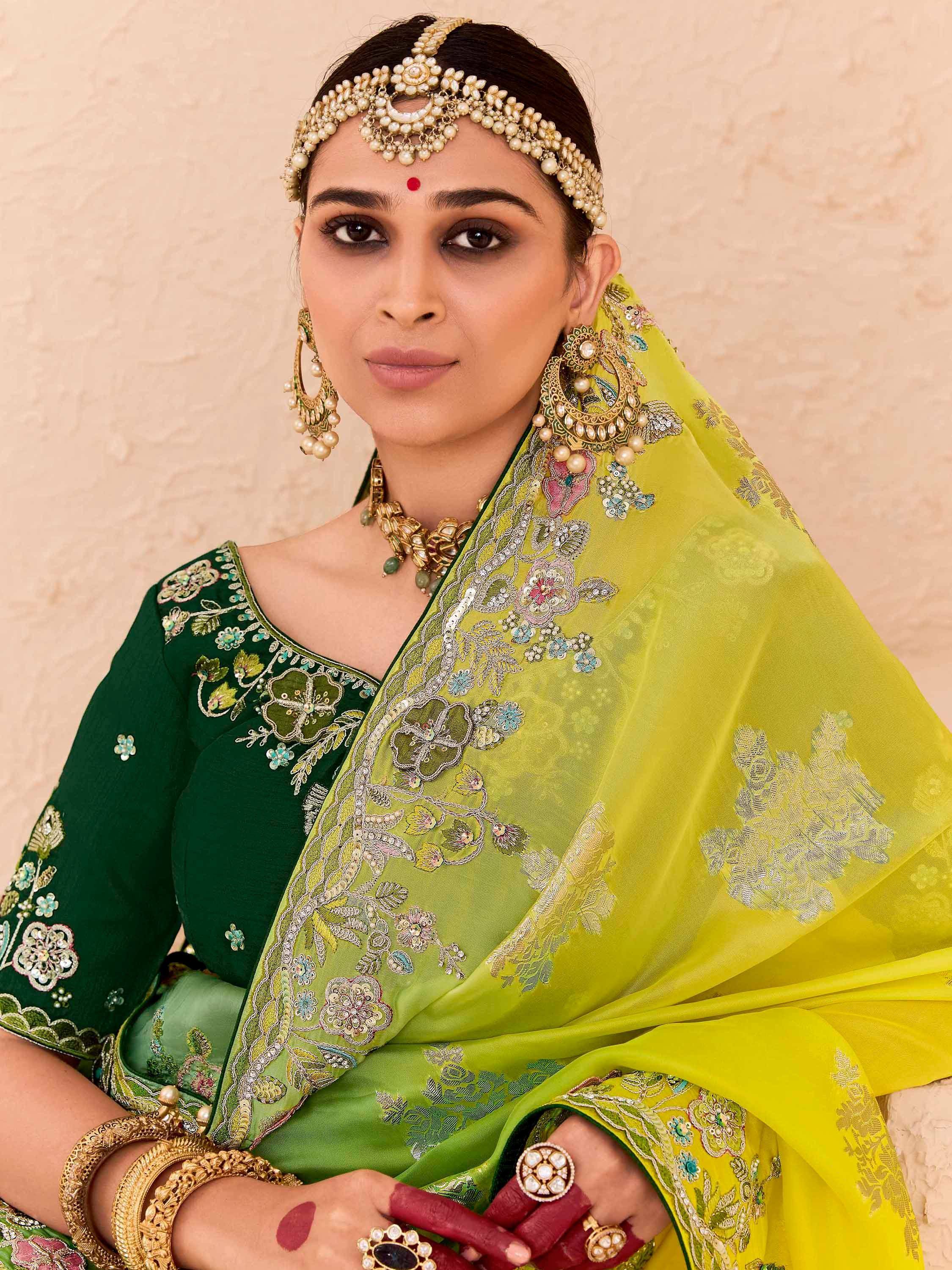 Elegant green embroidered Indian ethnic wear with floral dupatta and traditional jewelry