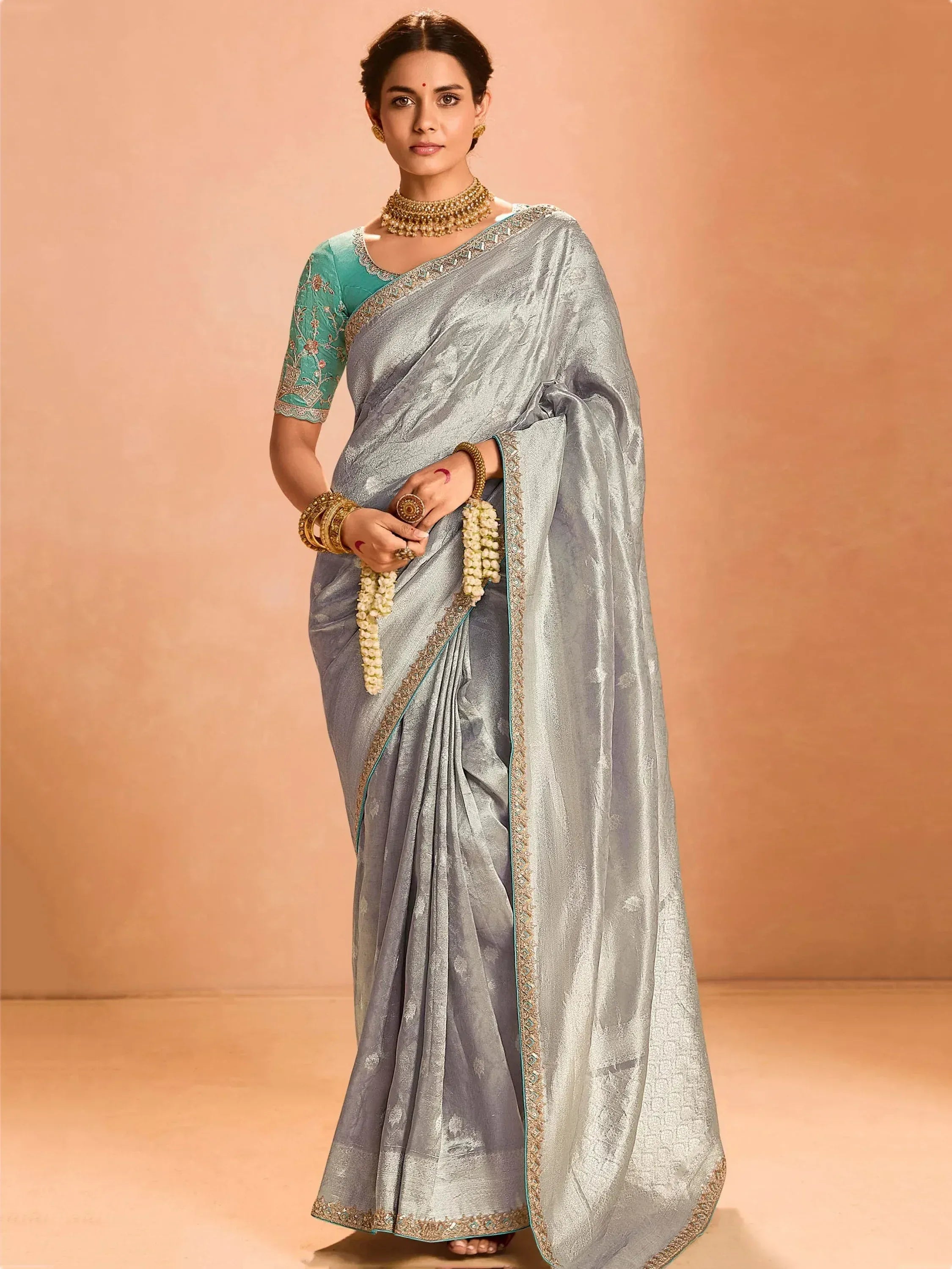 Elegant silver saree with teal blouse, perfect for Indian ethnic wear occasions