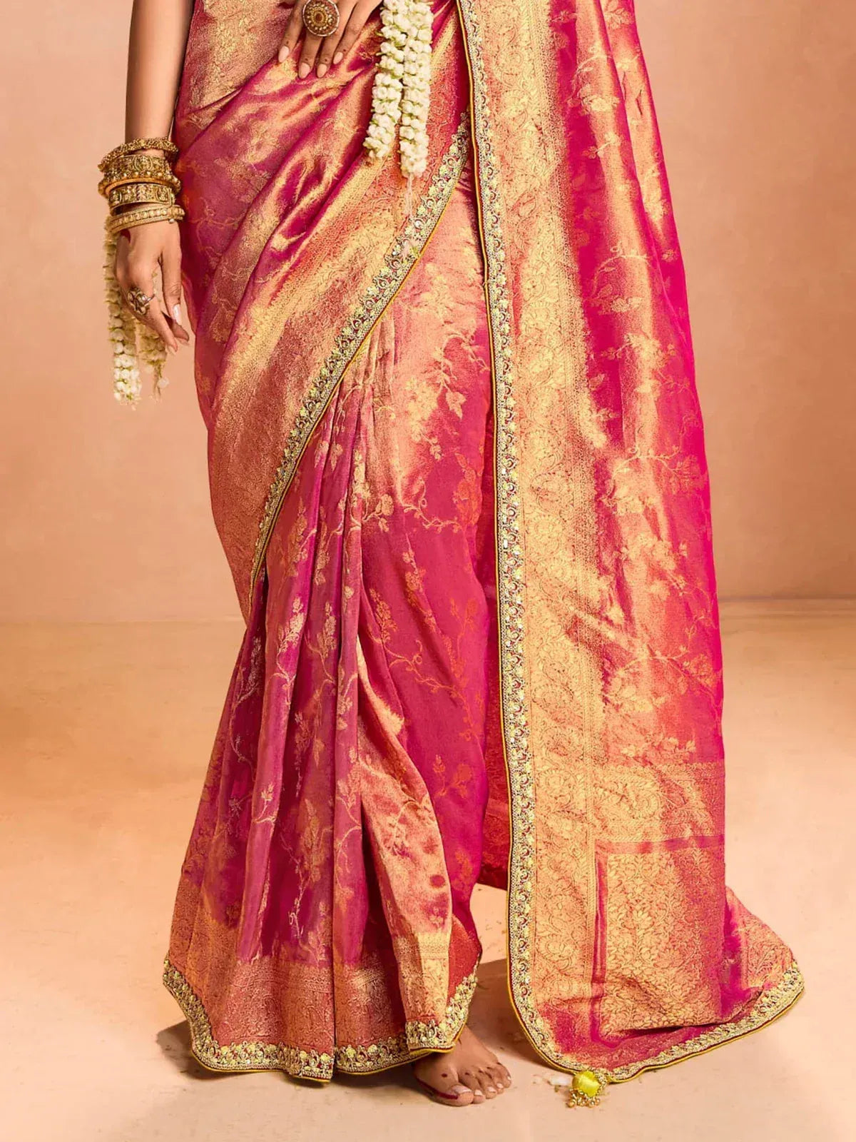 Pink and gold designer saree with intricate embroidery and floral motifs, perfect for Indian ethnic occasions