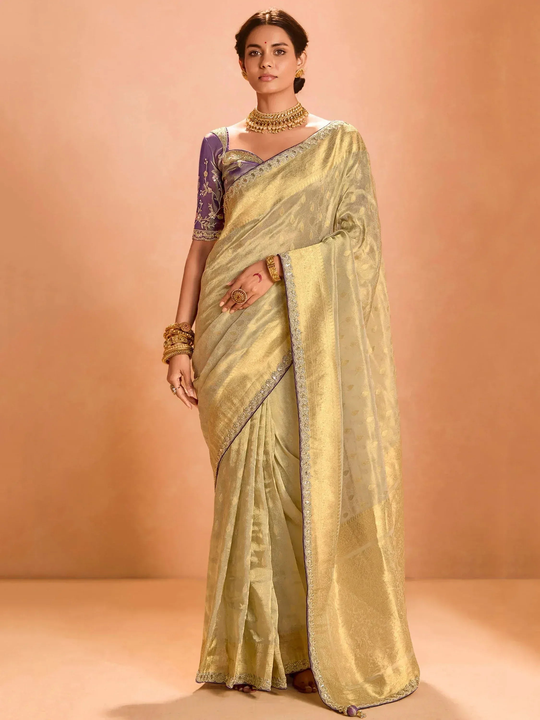 Elegant gold saree with purple blouse, perfect for Indian ethnic wear occasions
