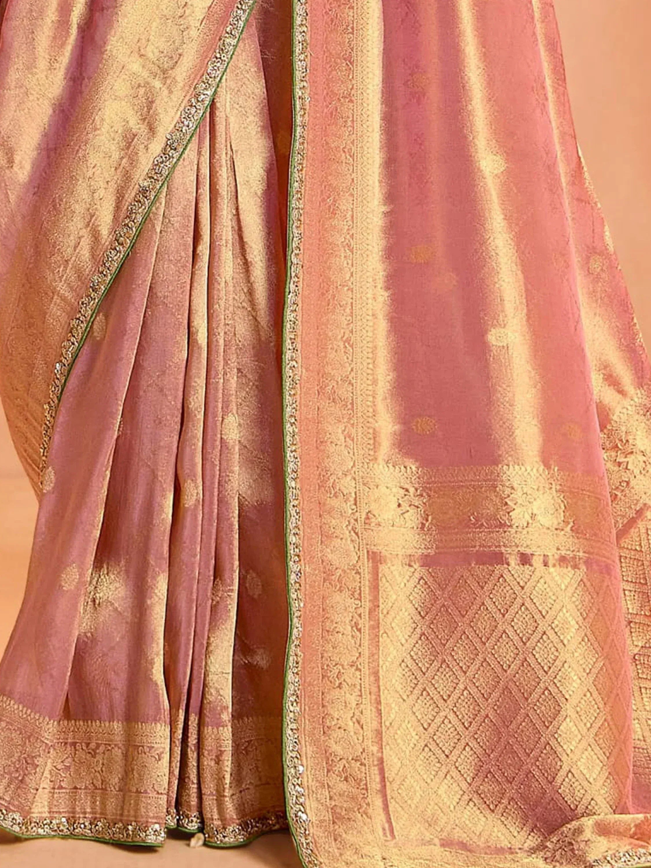 Pink and gold designer saree with intricate zari work and green border, perfect for ethnic occasions