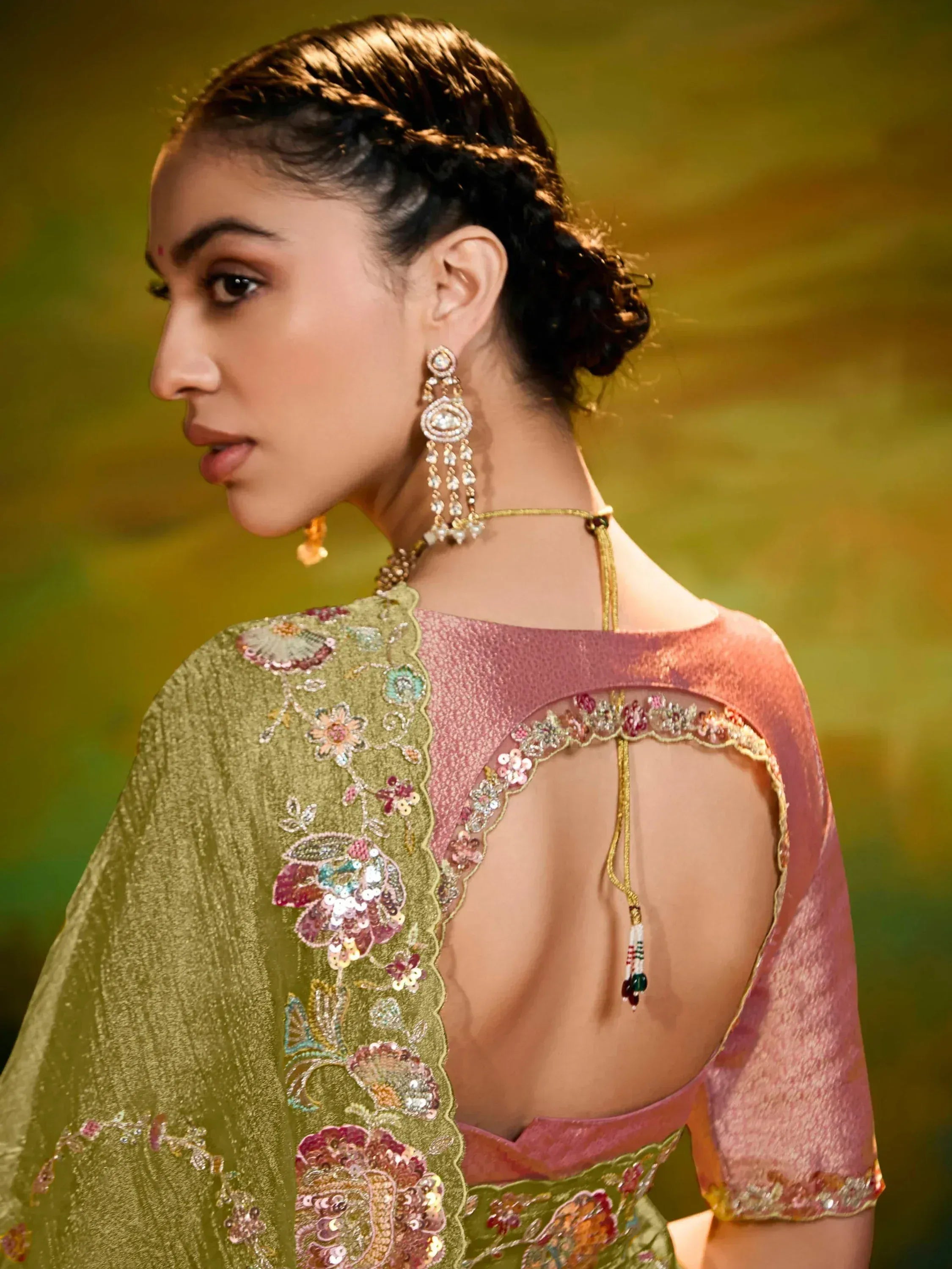 Elegant Indian ethnic wear with floral embroidery, backless pink blouse, and gold dupatta for festive occasions