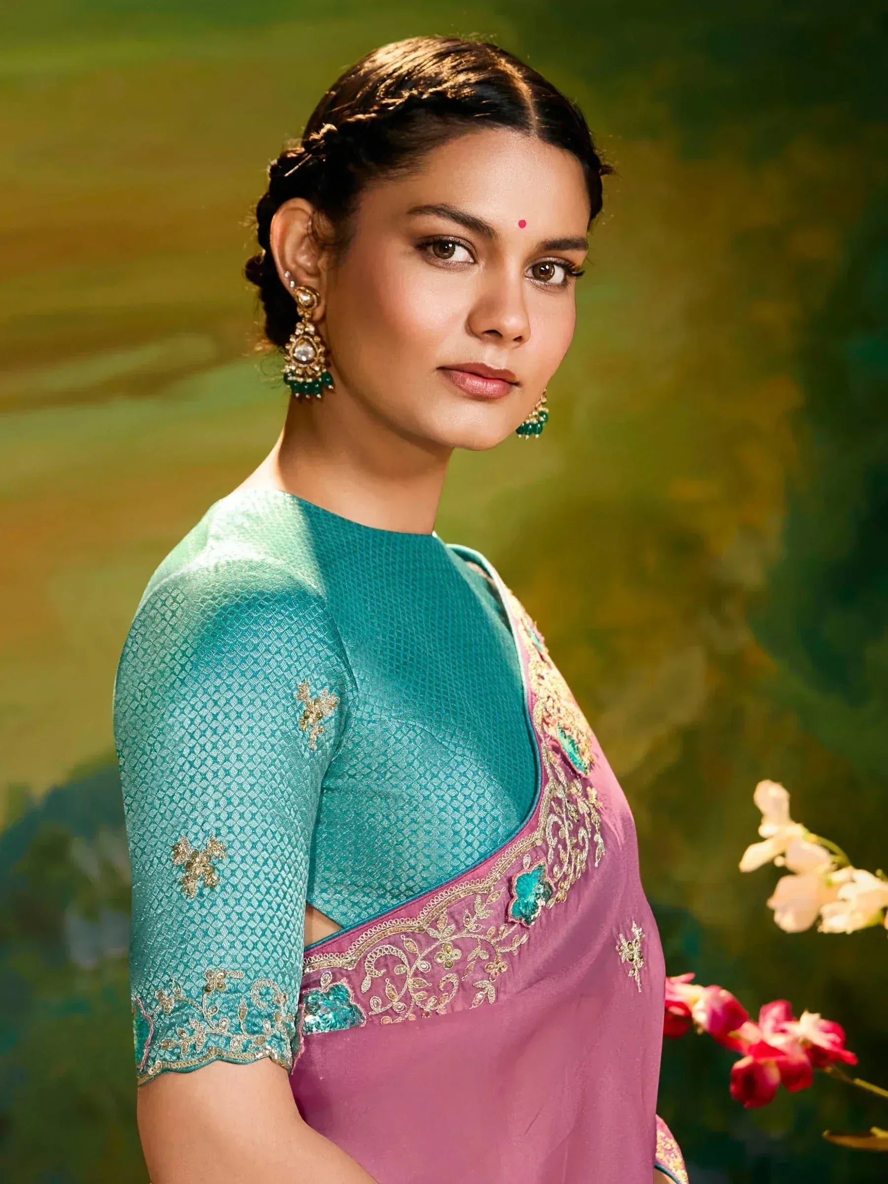 Woman in elegant pink and teal saree with gold embroidery, traditional Indian ethnic wear