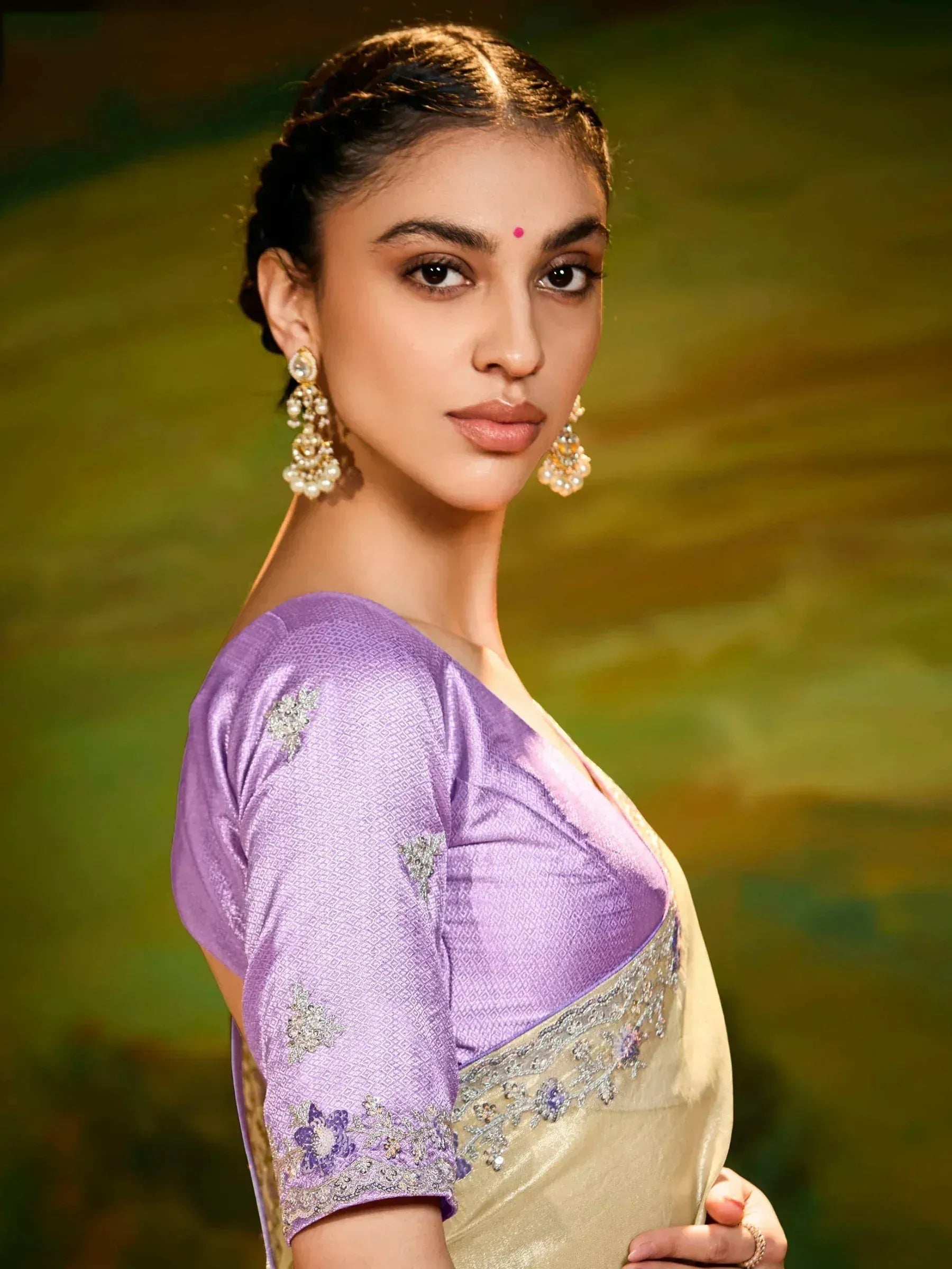 Woman in purple and gold embroidered saree with designer blouse, ethnic Indian wear