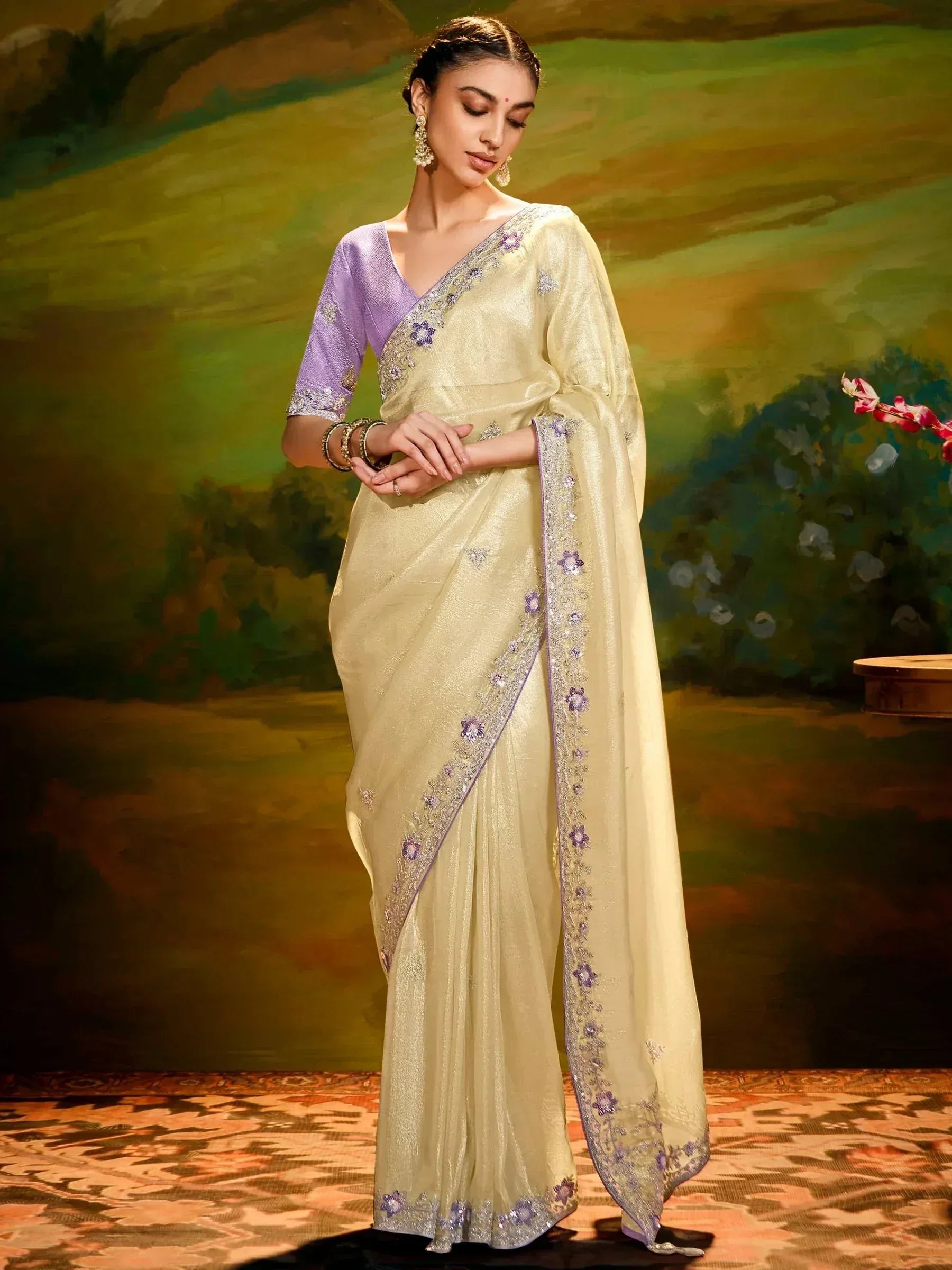 Elegant cream saree with purple floral embroidery and matching blouse, perfect for Indian ethnic occasions