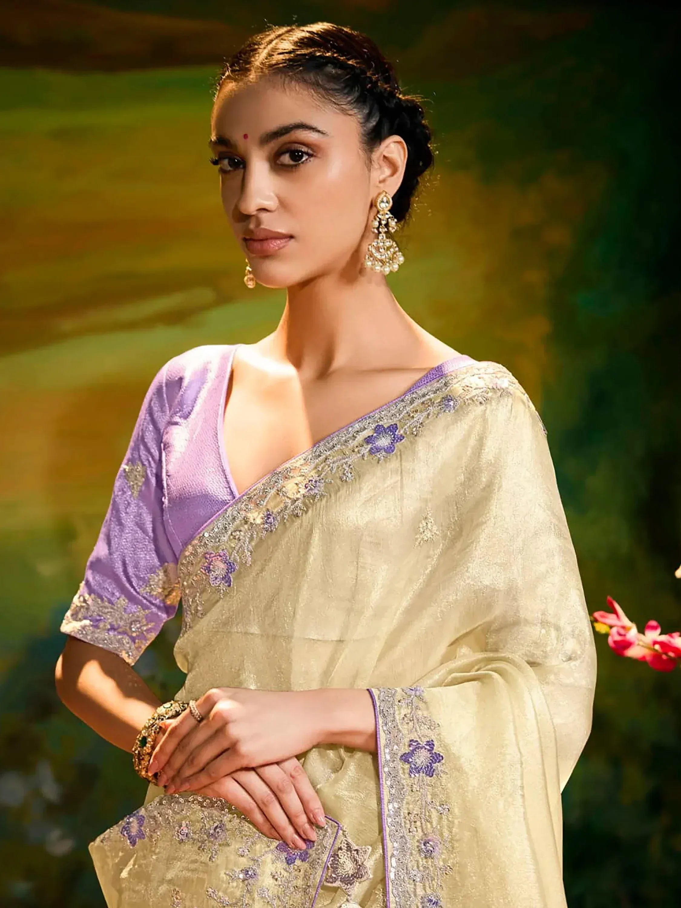 Elegant Indian saree with purple blouse, floral embroidery, and gold detailing for festive occasions