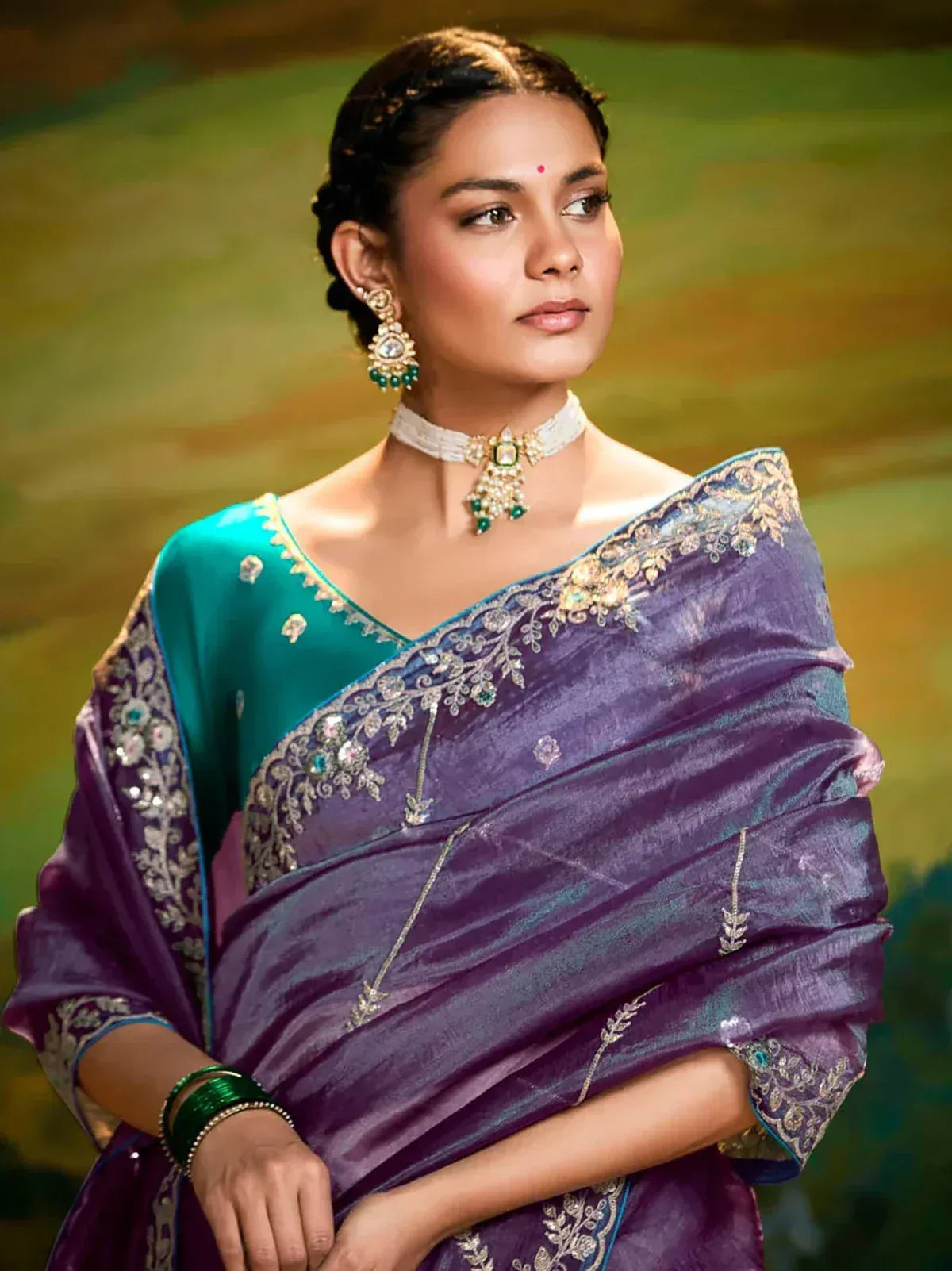 Elegant purple and teal saree with intricate gold embroidery and matching jewelry for Indian ethnic wear