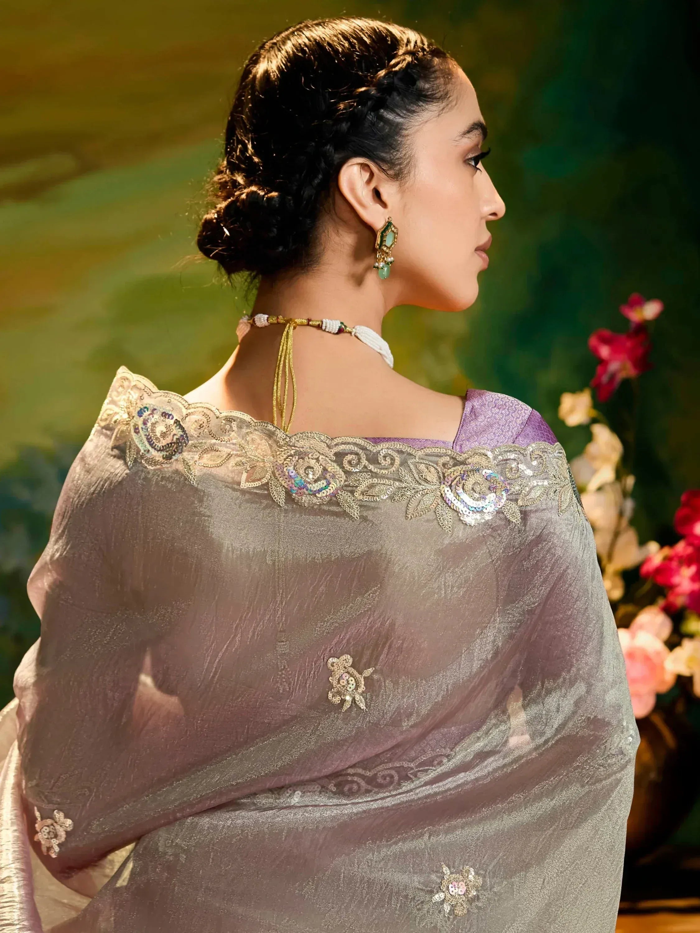 Elegant purple saree with gold embroidery and sequin detailing, styled with traditional jewelry for Indian ethnic wear.