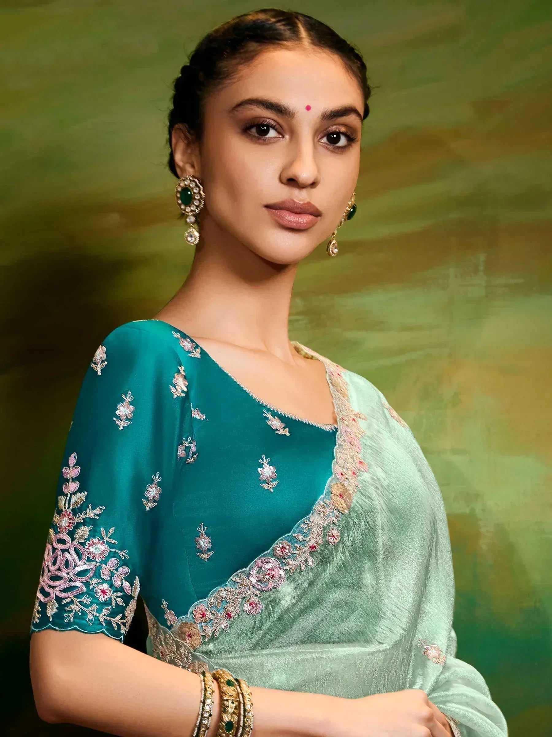 Teal embroidered saree with floral detailing, perfect for Indian ethnic wear occasions