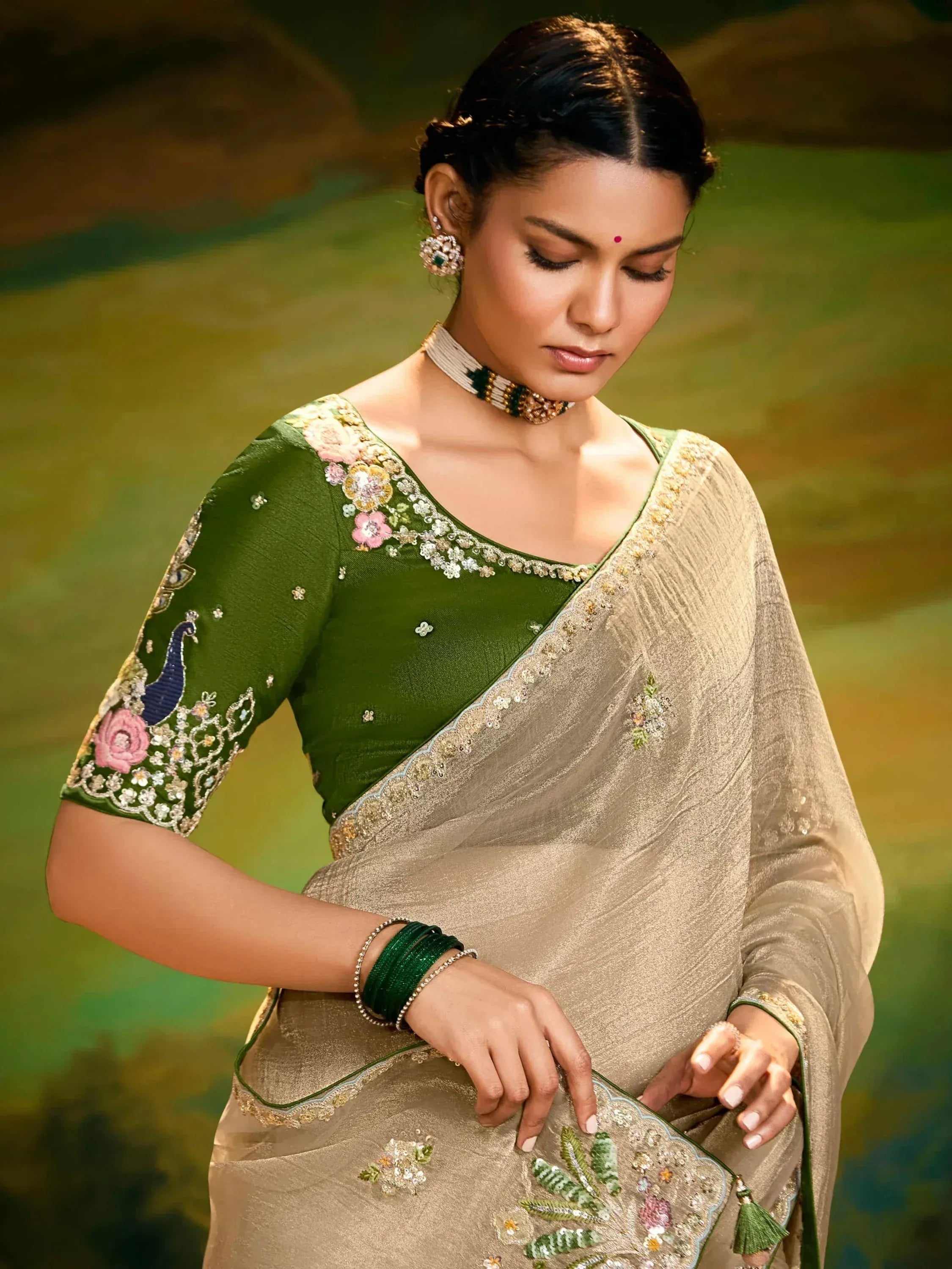 Elegant green and gold embroidered saree with floral and peacock motifs, perfect for Indian ethnic occasions.