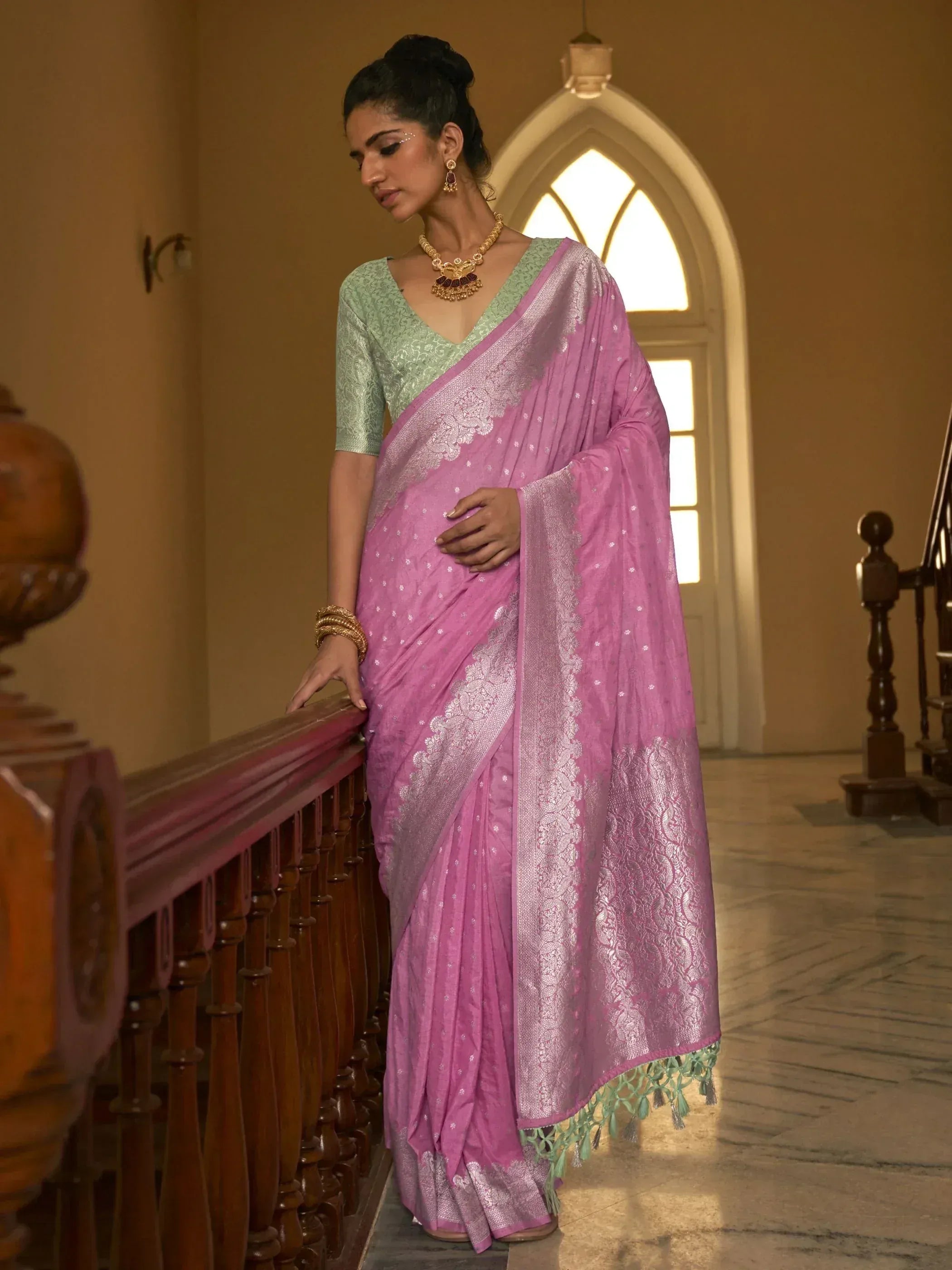 Woman in pink designer saree with silver zari work and green blouse, ethnic wear for festive occasions