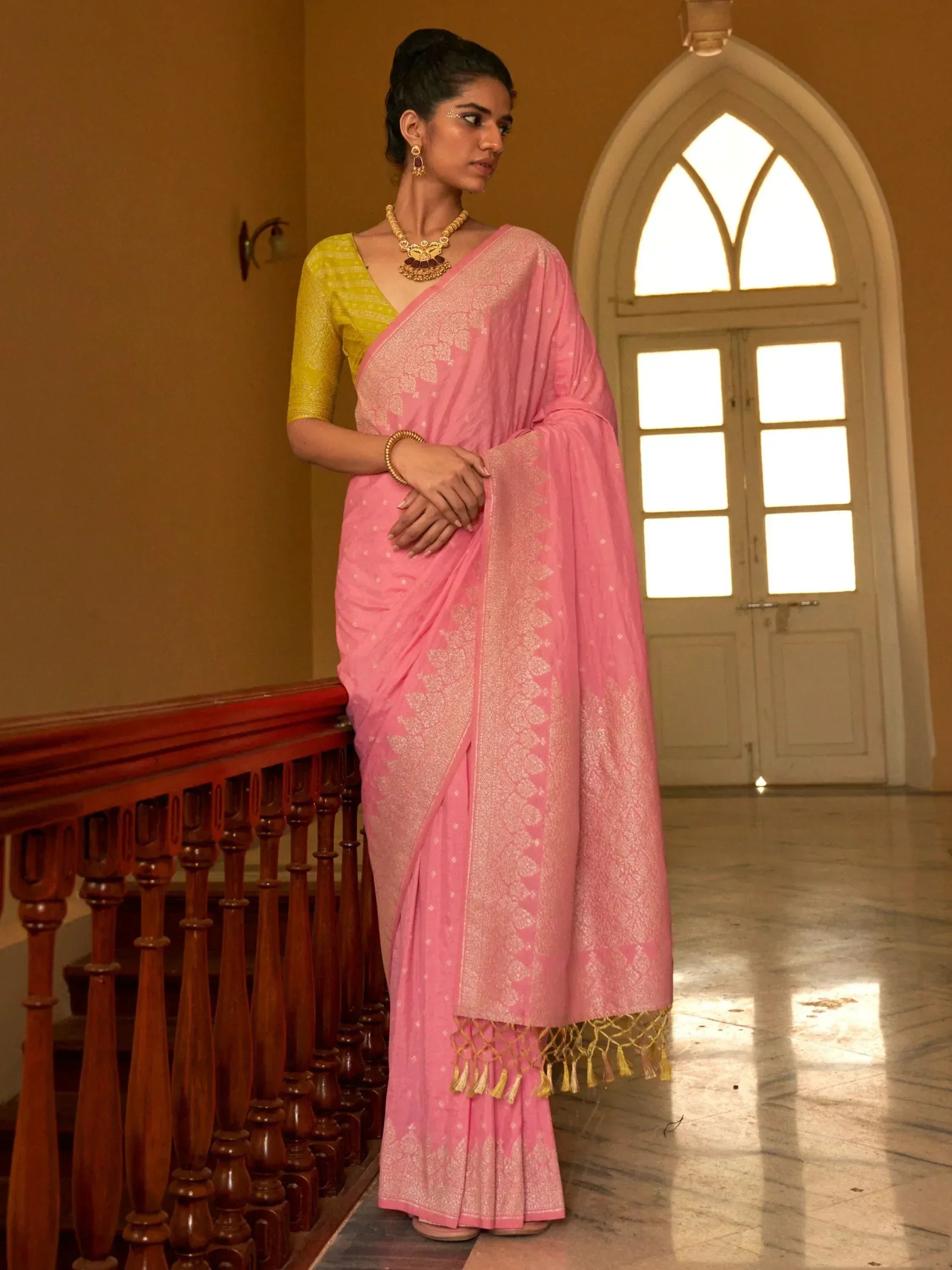 Pink embroidered saree with gold border and yellow blouse, traditional Indian ethnic wear