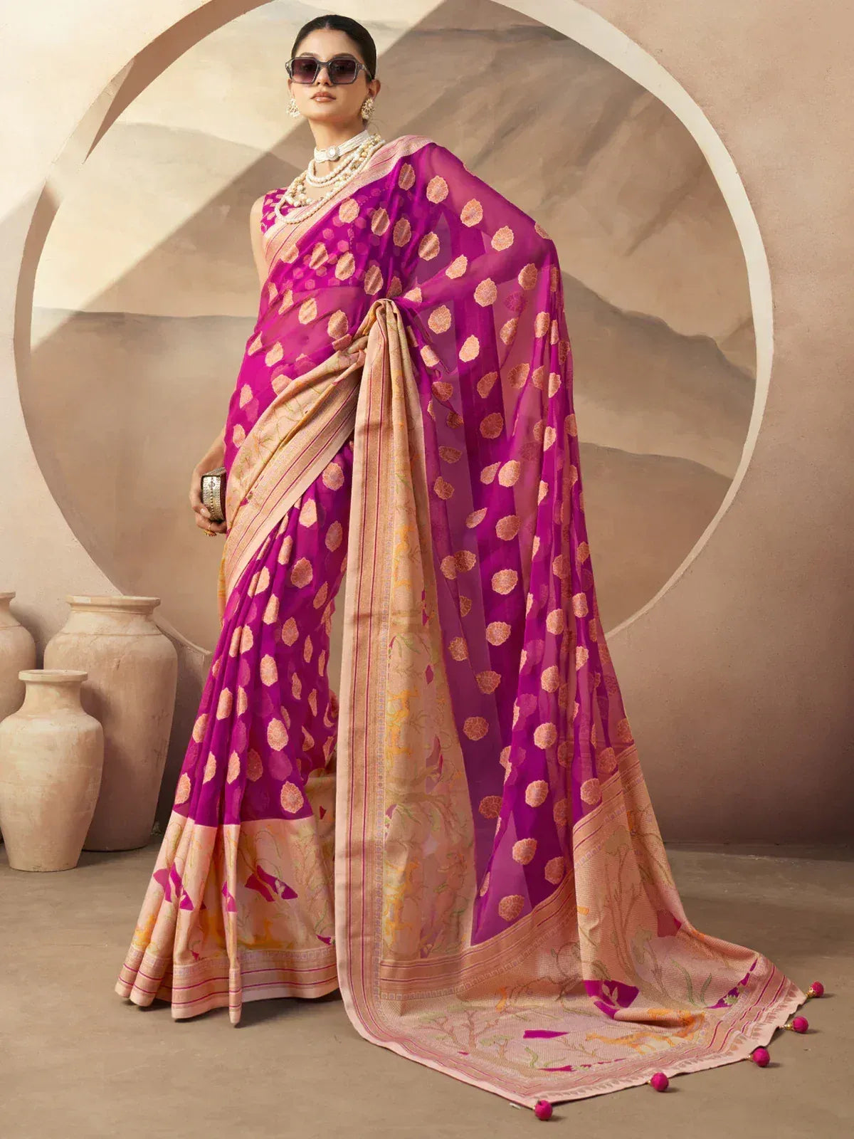 Vibrant pink and peach designer saree with floral motifs, perfect for Indian ethnic wear occasions