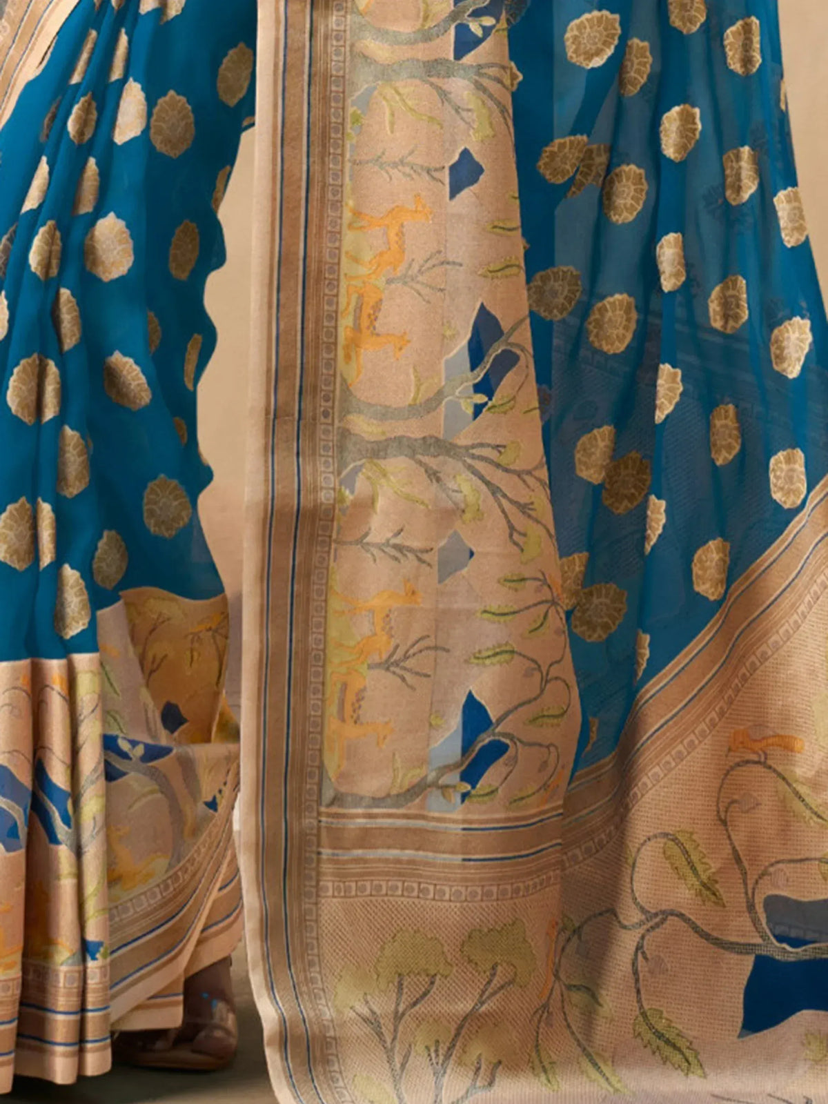 Blue and beige saree with floral and deer motifs, perfect for ethnic wear occasions