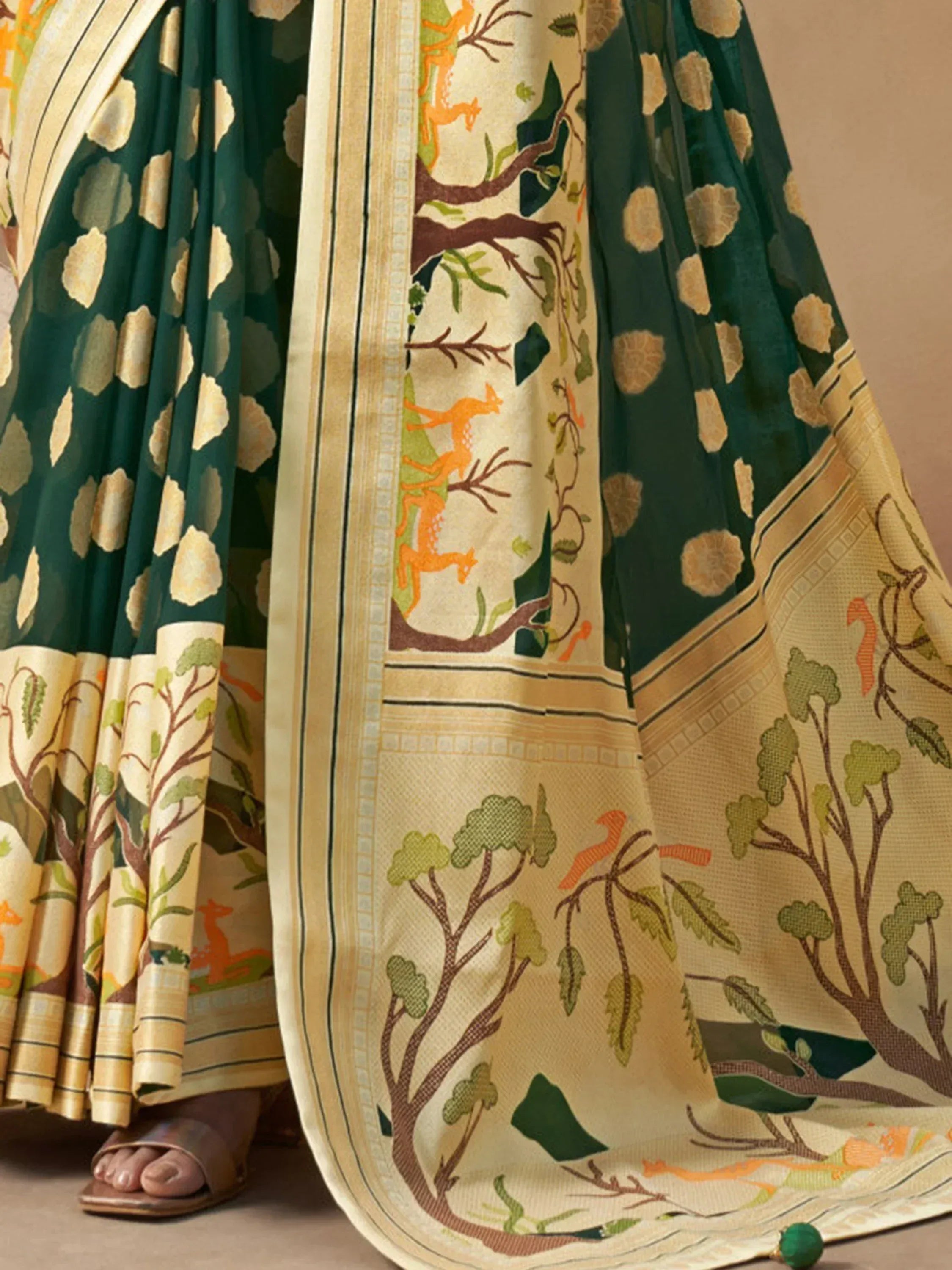 Green and cream saree with forest print, deer motifs, and golden border for ethnic wear