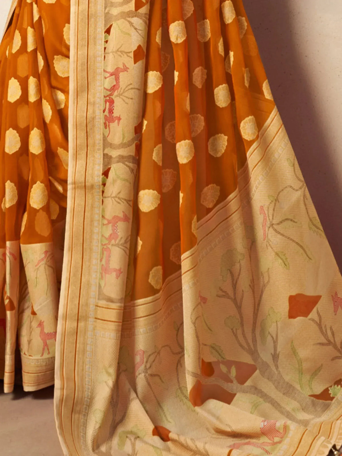 Orange and cream ethnic saree with floral and deer print, perfect for Indian occasions