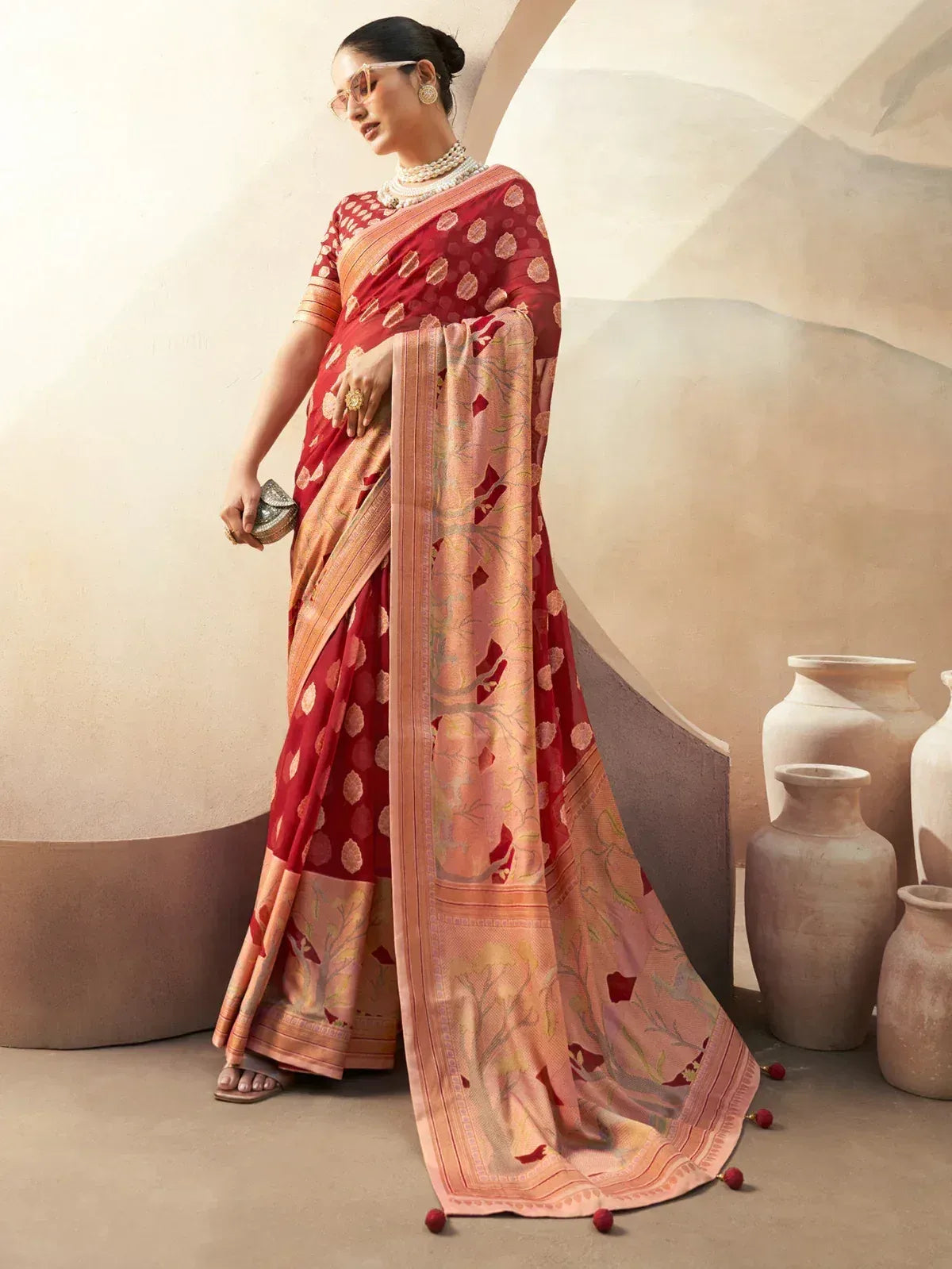 Red and peach designer saree with floral motifs, perfect for ethnic occasions