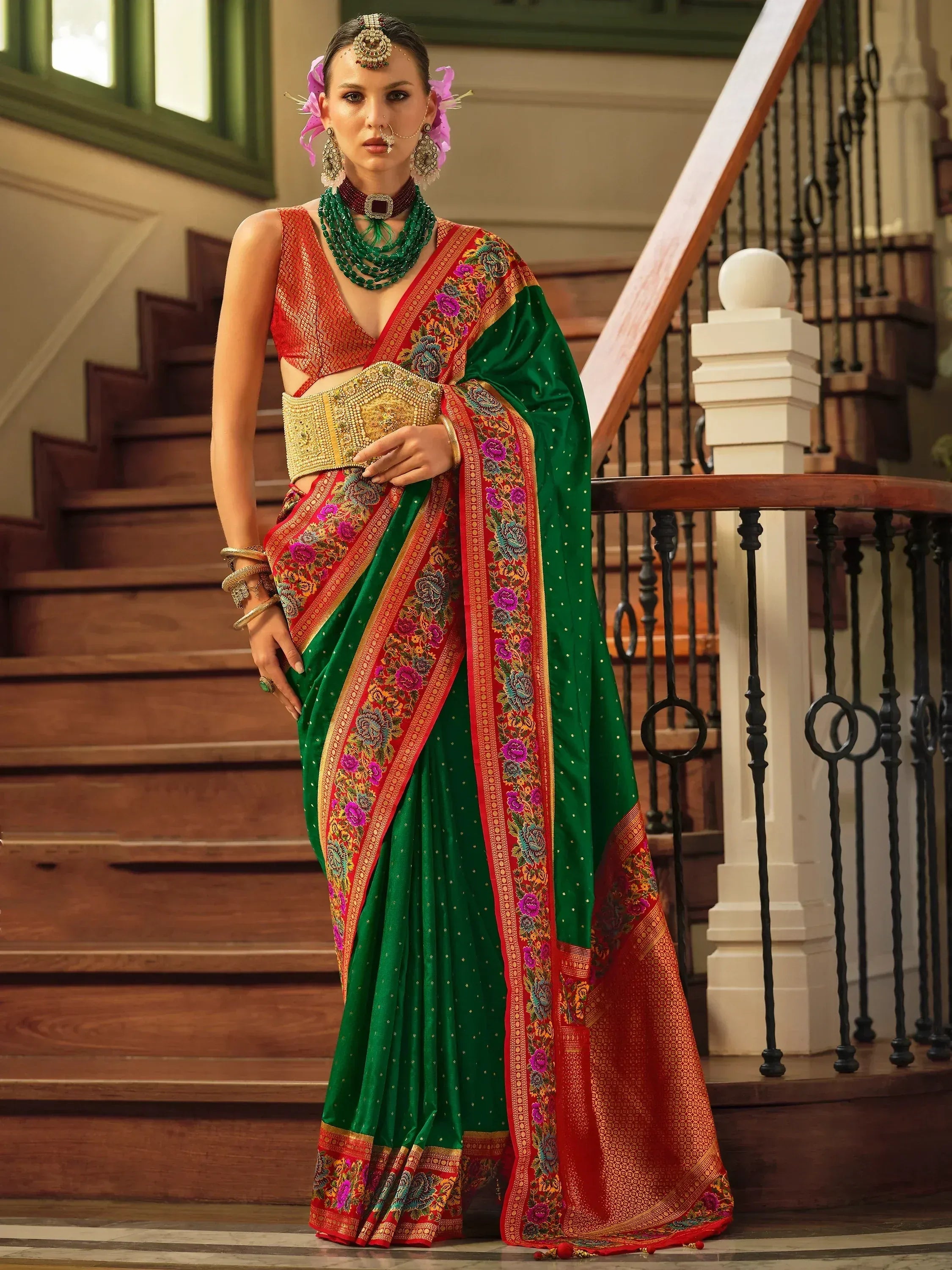 Elegant green and red embroidered saree with gold belt, perfect for Indian ethnic wear occasions.