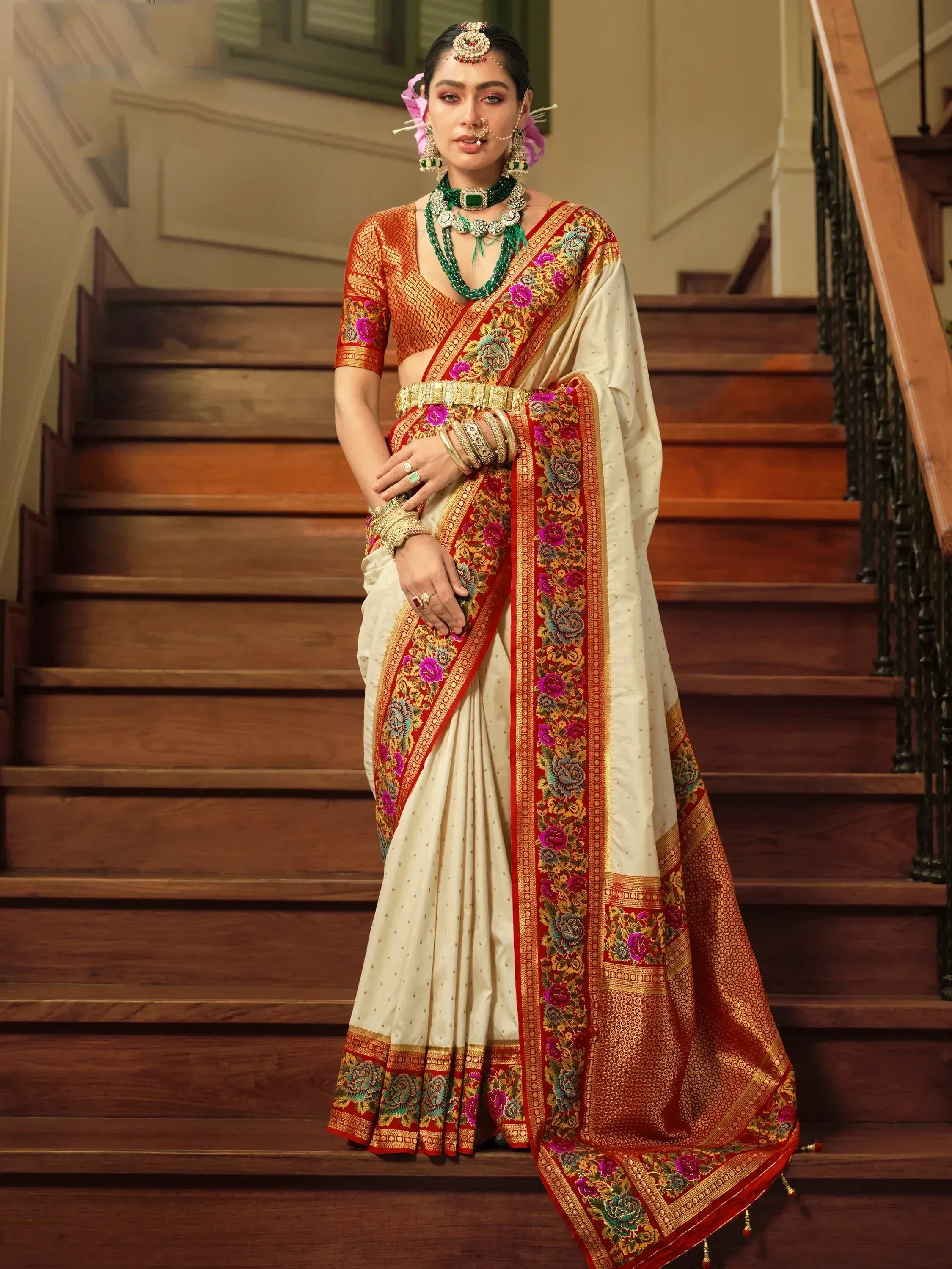 Elegant cream saree with red floral border, gold embroidery, and matching blouse for Indian ethnic wear