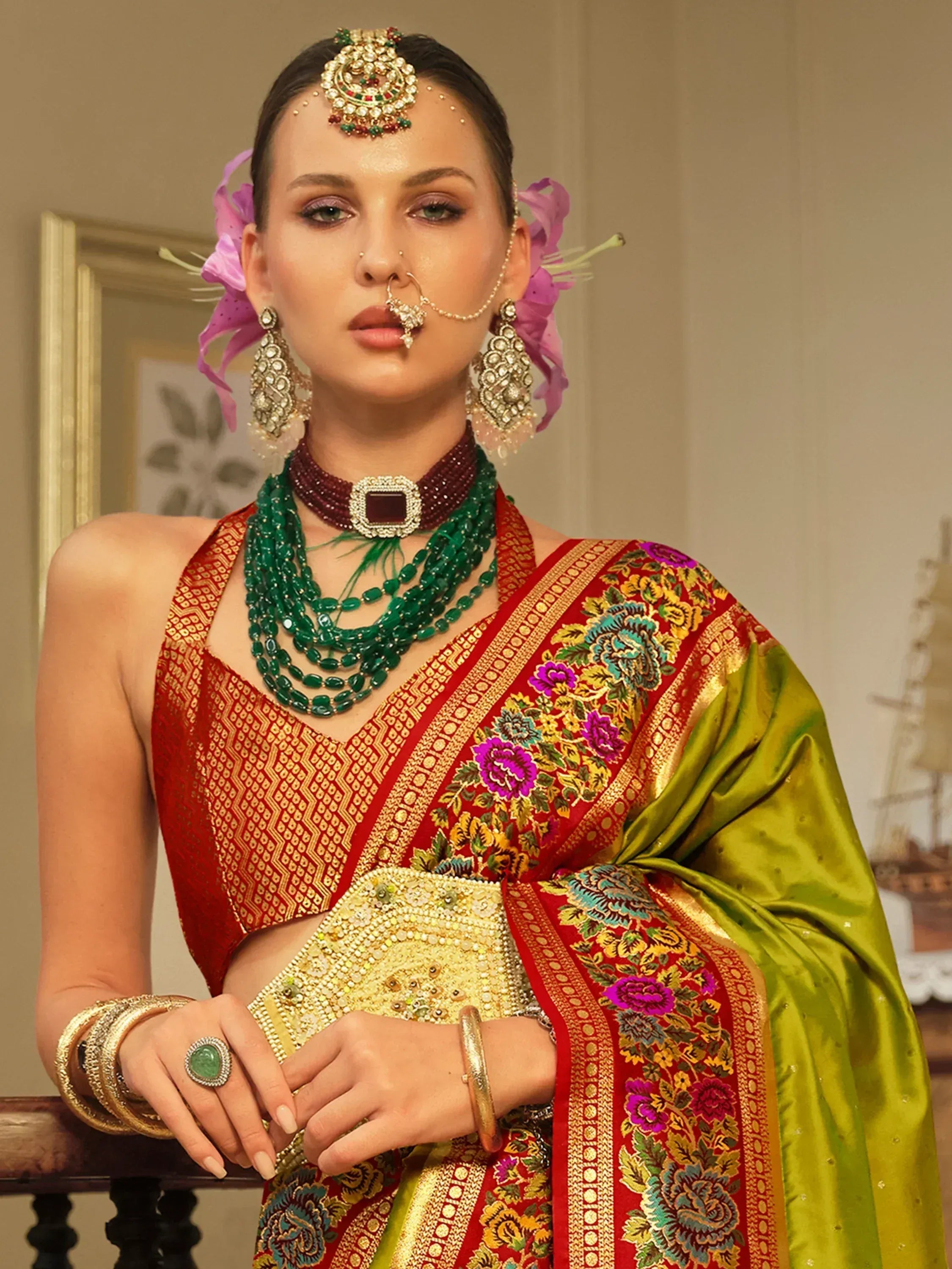 Indian bridal lehenga choli with floral embroidery, green dupatta, and traditional jewelry