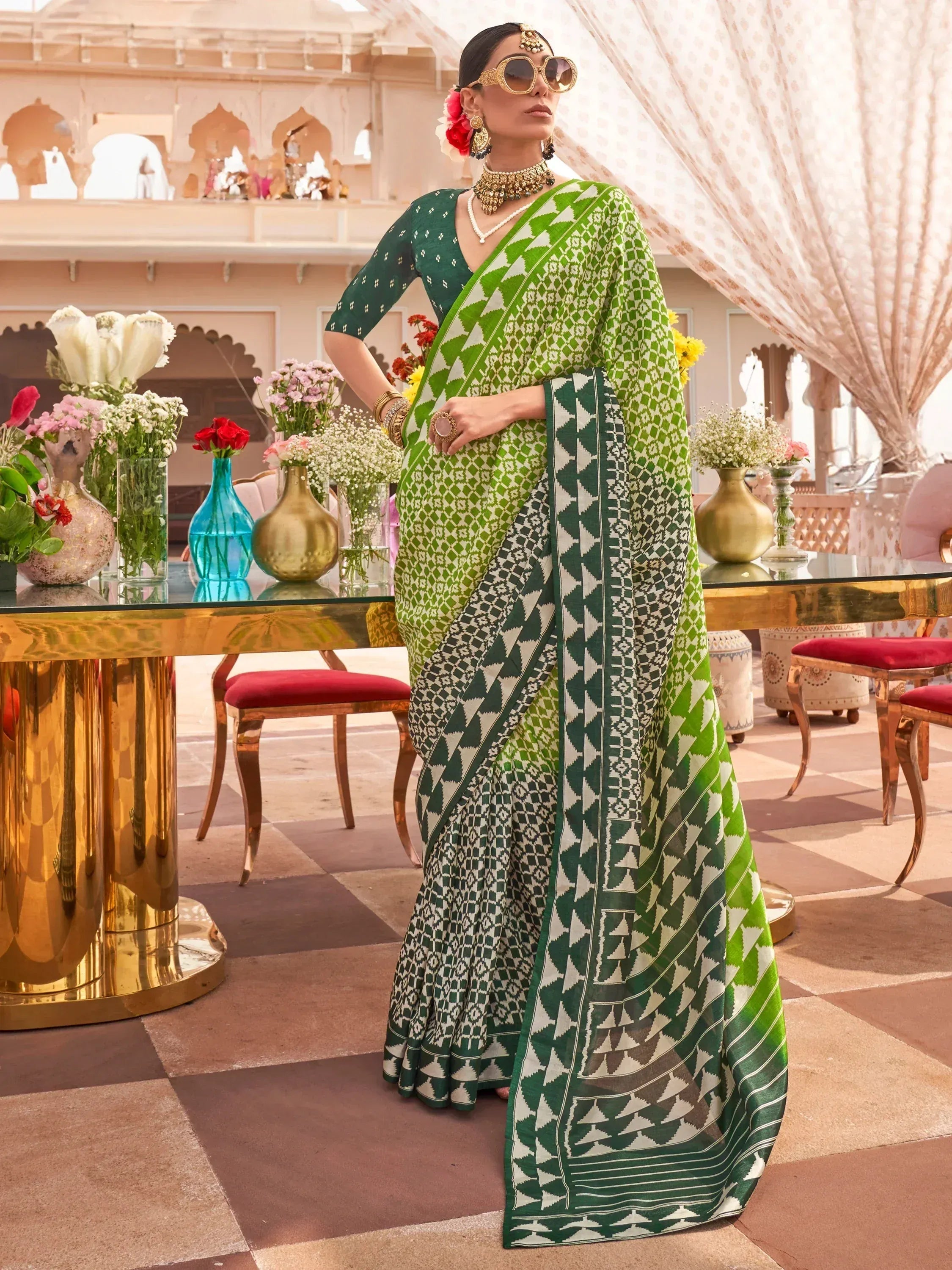 Green and white patterned designer saree with ethnic jewelry, styled for Indian festive wear