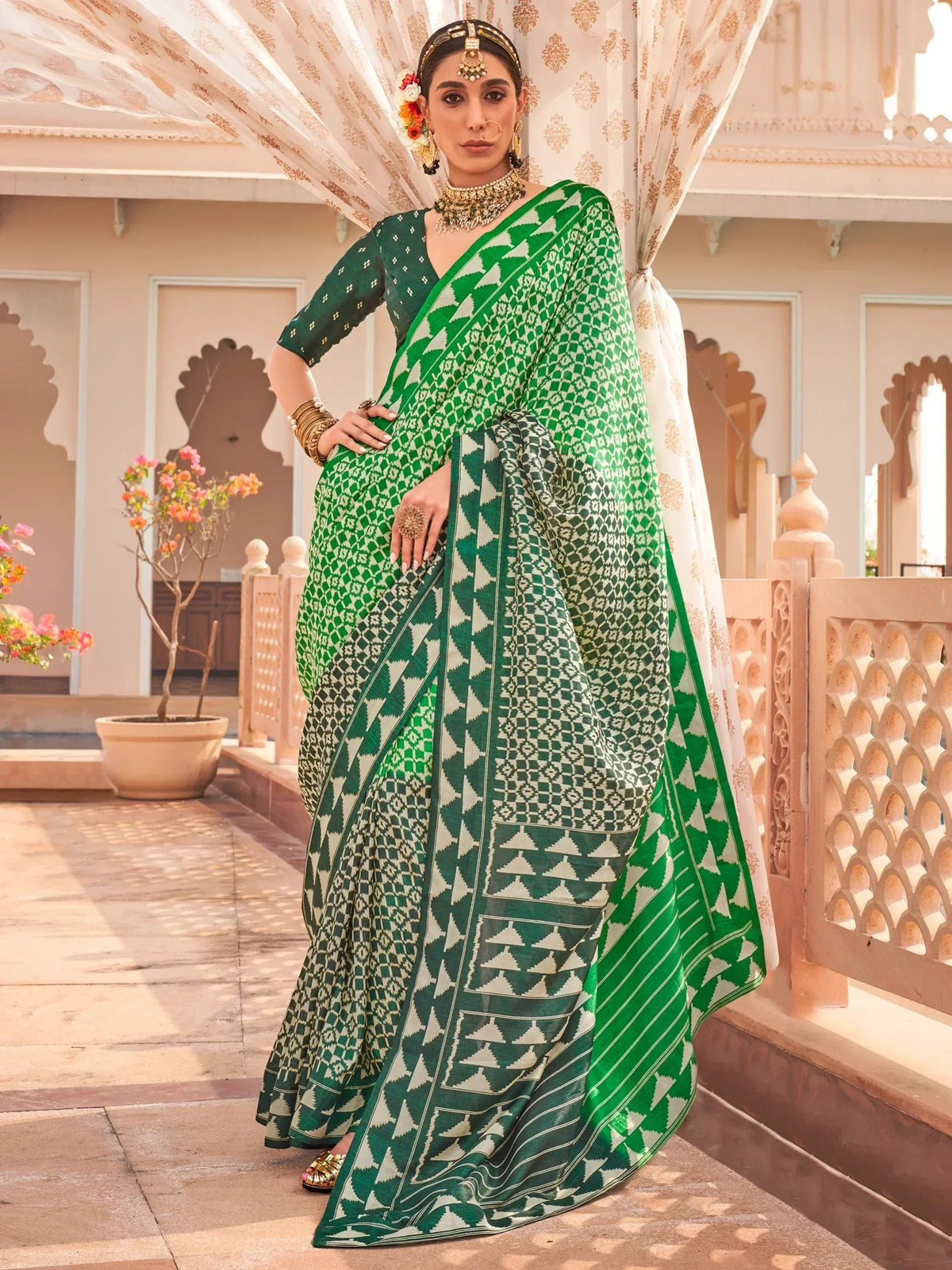 Green and white geometric print saree with ethnic jewelry, perfect for Indian festive occasions