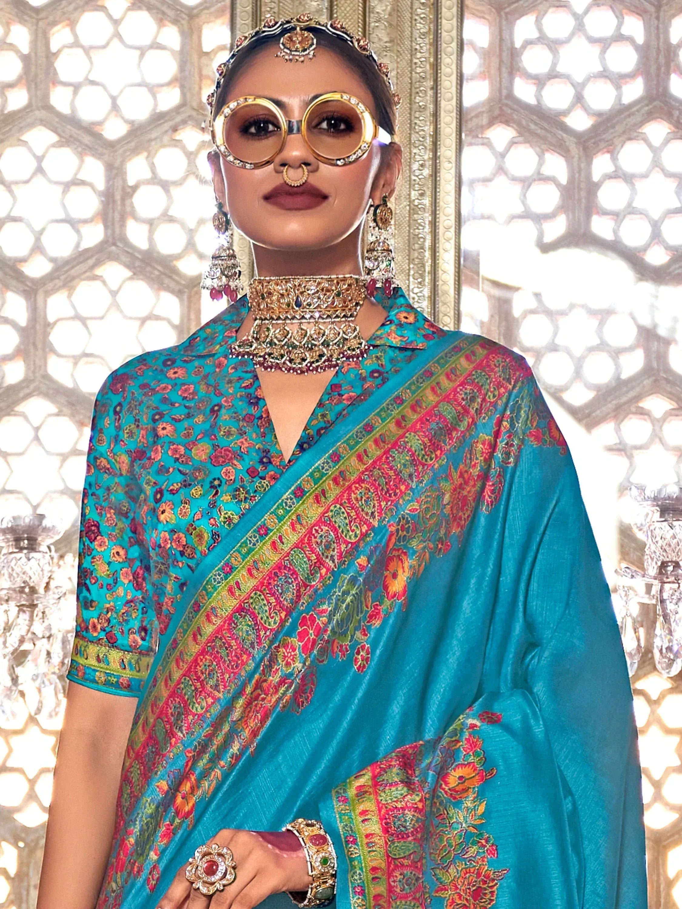 Turquoise floral saree with red border, traditional Indian ethnic wear, designer jewelry, and ornate headpiece