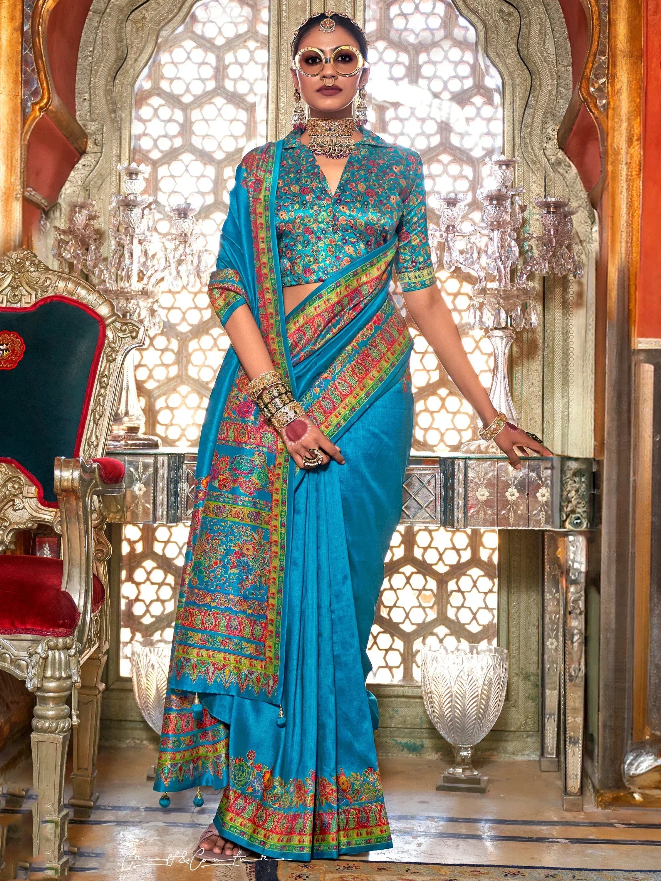 Blue floral printed saree with matching blouse, ethnic jewelry, and traditional Indian attire for festive occasions