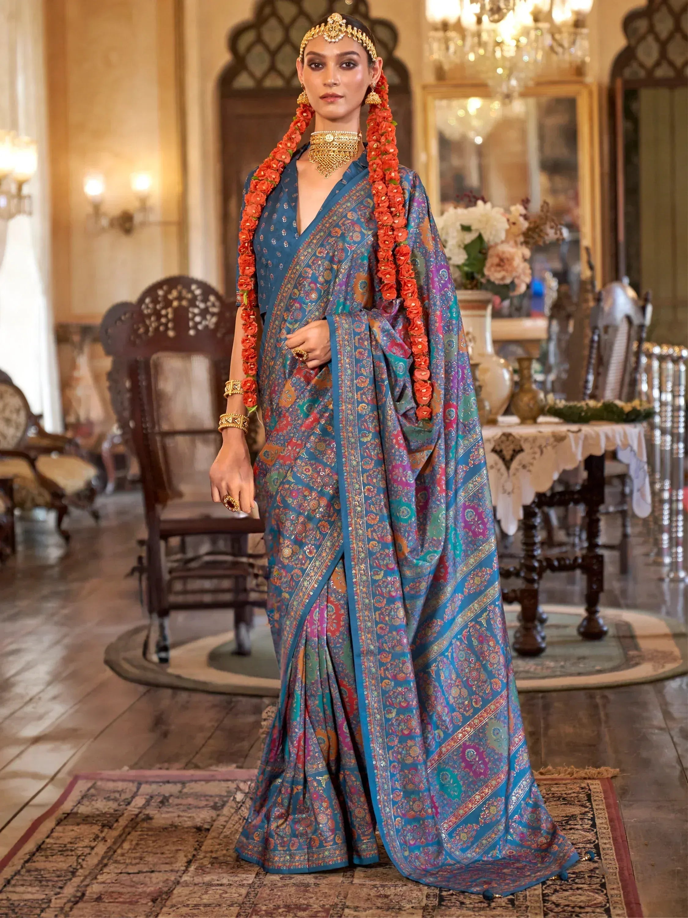 Blue floral printed saree with gold jewelry, perfect for Indian ethnic wear occasions