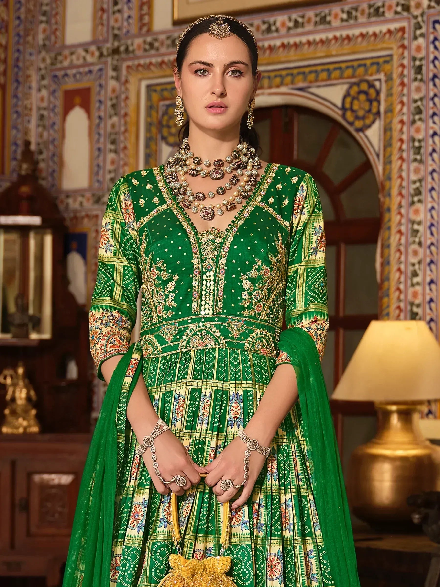 Emerald green embroidered anarkali suit with gold detailing, perfect for Indian ethnic wear and festive occasions.