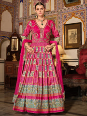 Woman in ornate pink Indian ethnic gown with gold embroidery, traditional jewelry, royal decor