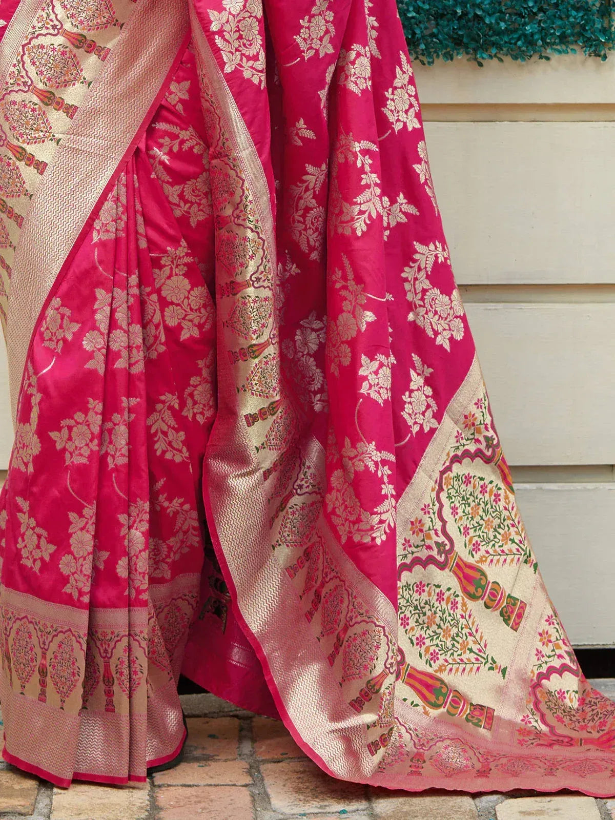 Pink floral Banarasi saree with gold zari border and intricate paisley motifs, perfect for ethnic occasions