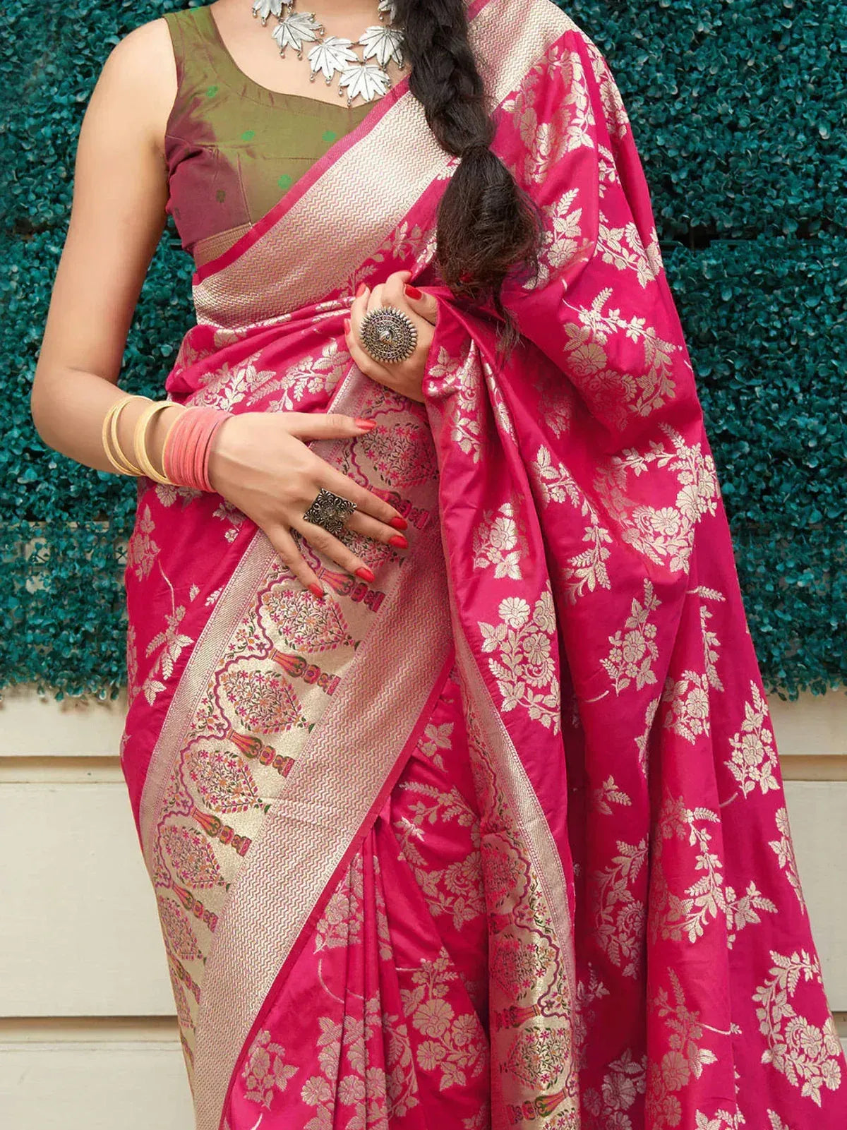 Pink floral Banarasi saree with gold zari border, paired with olive green blouse, perfect for Indian ethnic occasions.