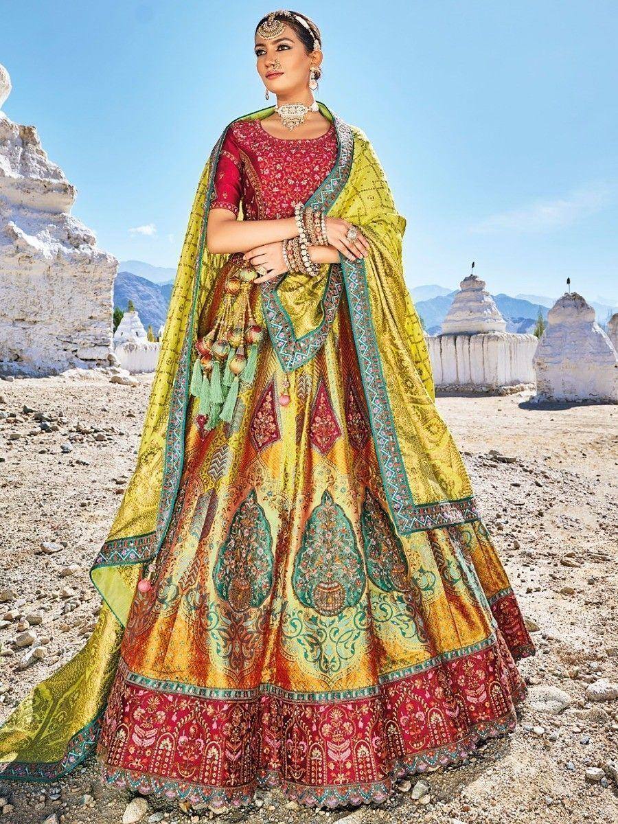 Designer lehenga choli with intricate embroidery, vibrant yellow and red hues, perfect for Indian ethnic wear