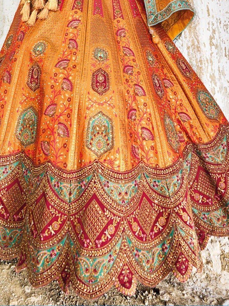 Orange designer lehenga with intricate embroidery and scalloped border, perfect for Indian ethnic wear